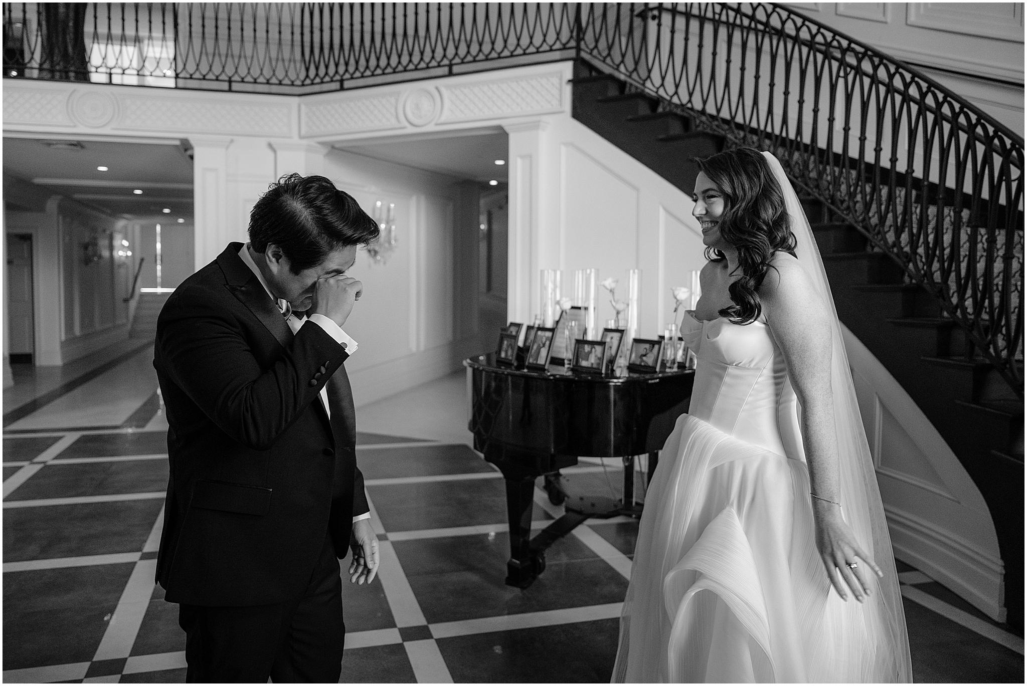 groom wipes away tears during first look inside lobby of the Estate at Florentine Gardens