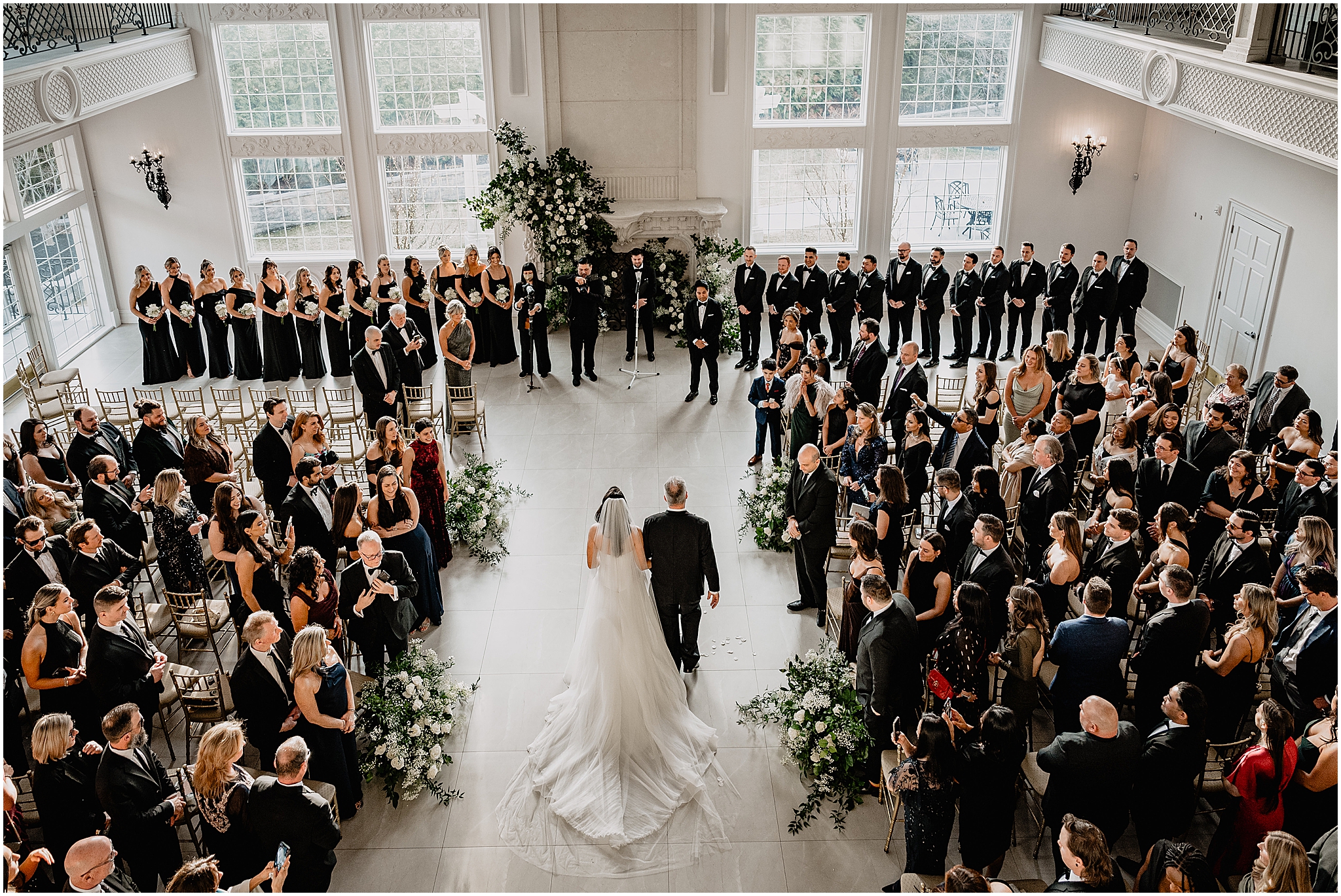 father escorts bride to alter inside ballroom at the Estate at Florentine Gardens