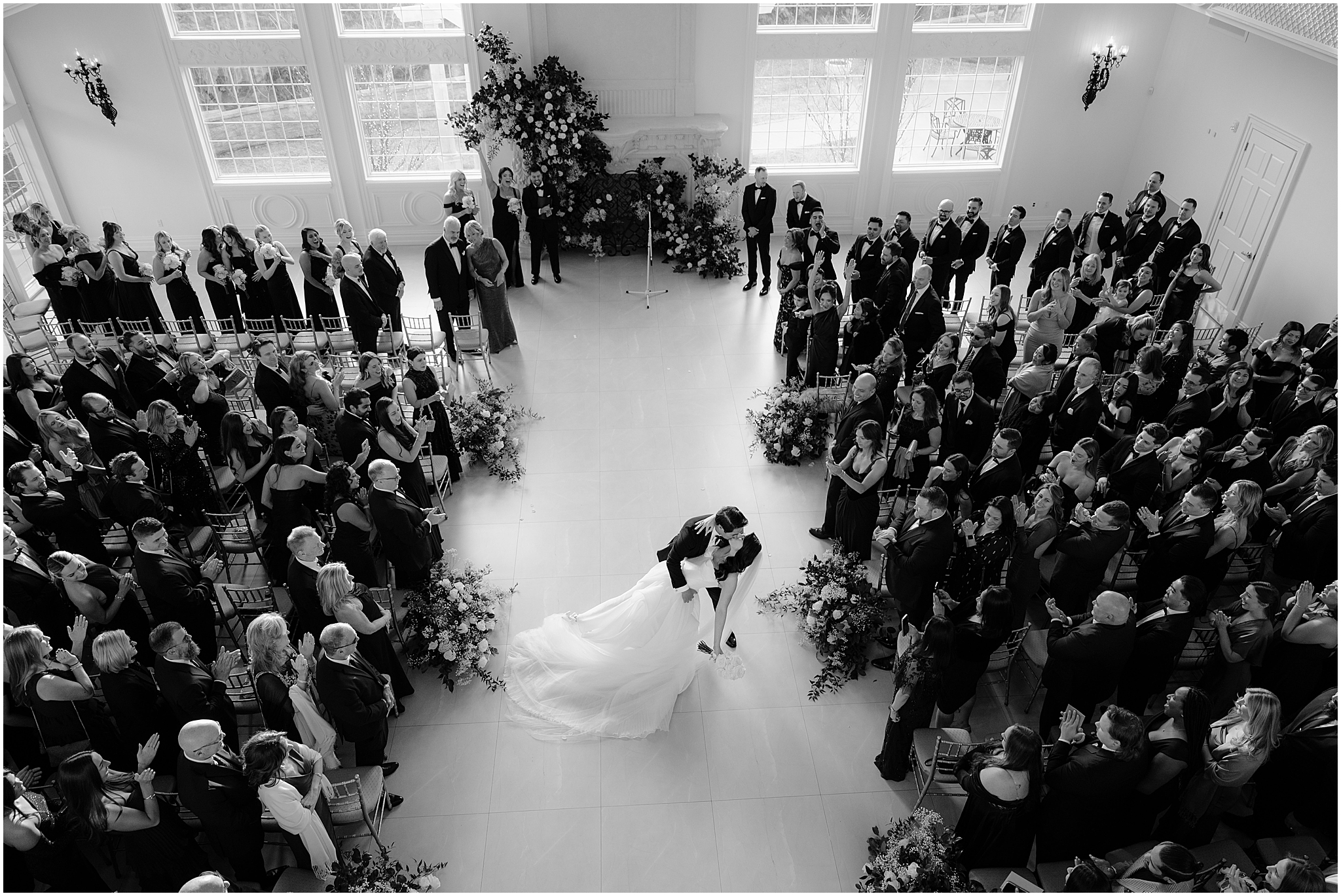 bride and groom kiss in aisle during wedding ceremony at the Estate at Florentine Gardens