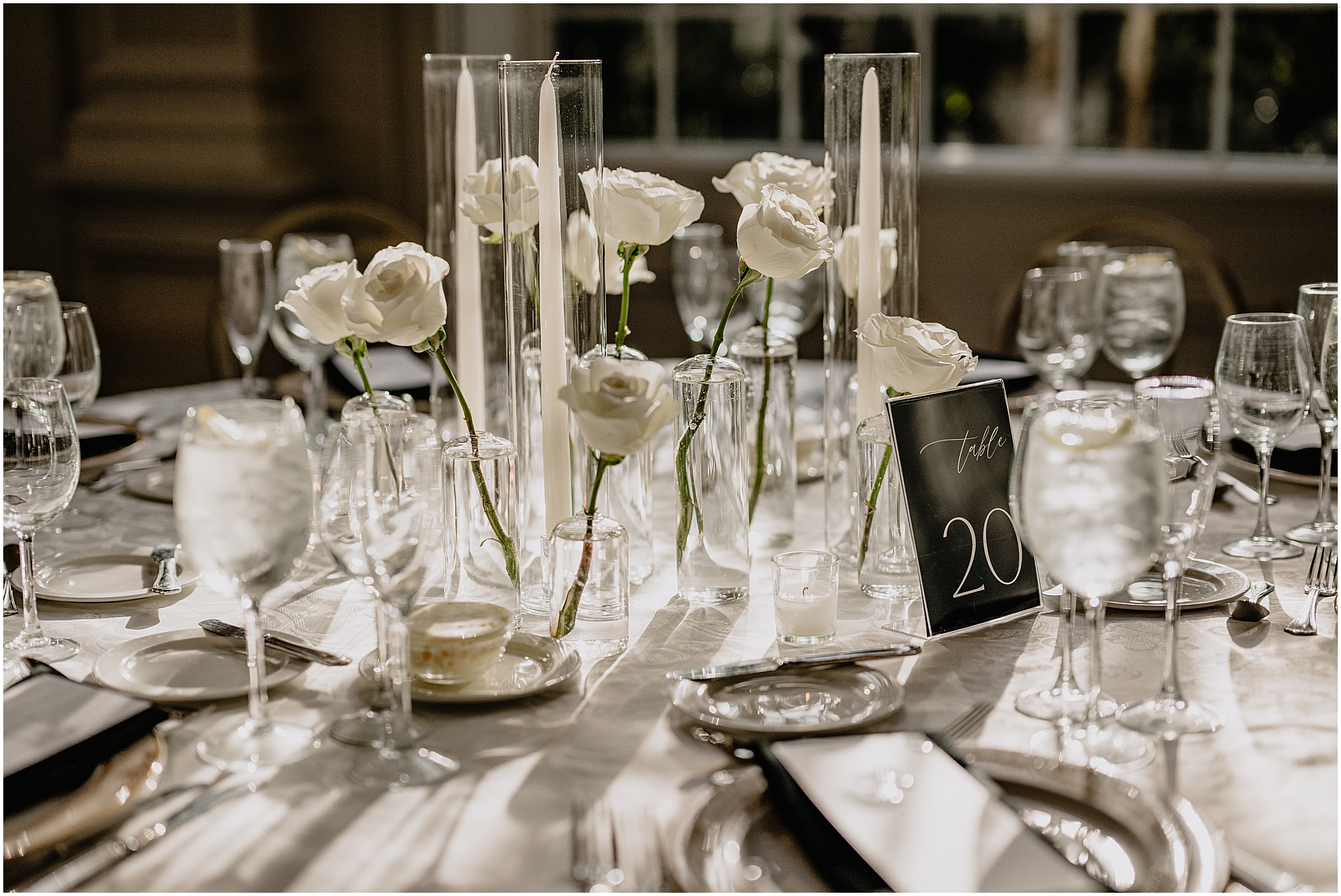 classic wedding reception at the Estate at Florentine Gardens with white taper candles and white roses