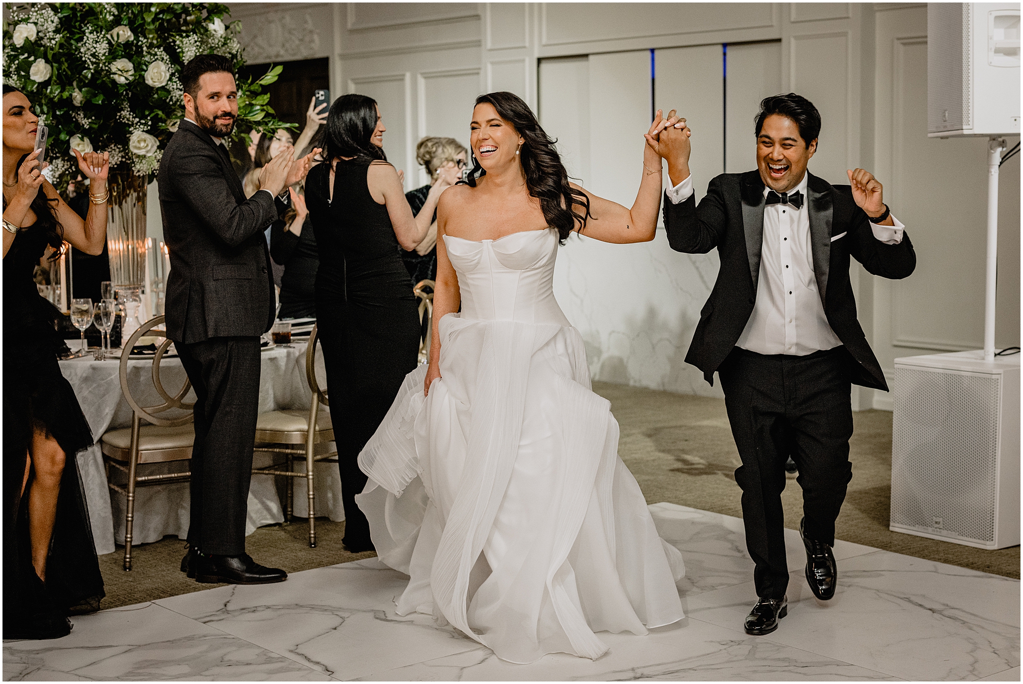 newlyweds cheer walking into wedding reception in barroom at the Estate at Florentine Gardens