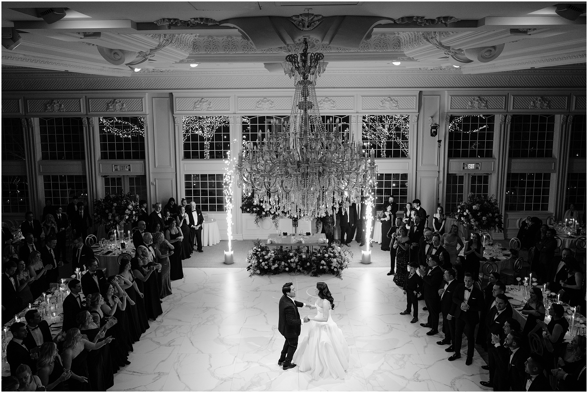 newlyweds dance together on marble floor while sparklers go off during reception at the Estate at Florentine Gardens