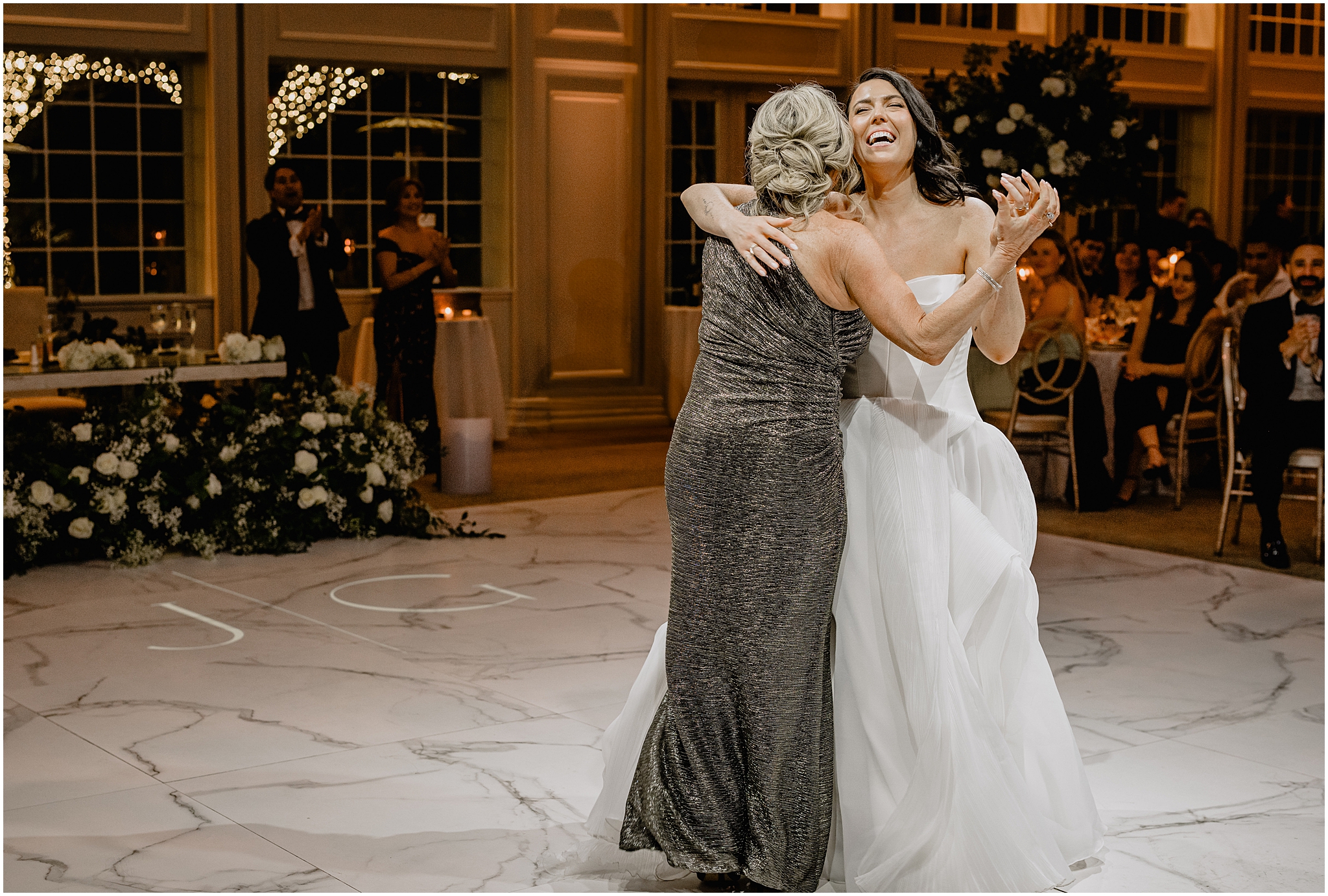 bride laughs dancing with mother during New Jersey wedding reception