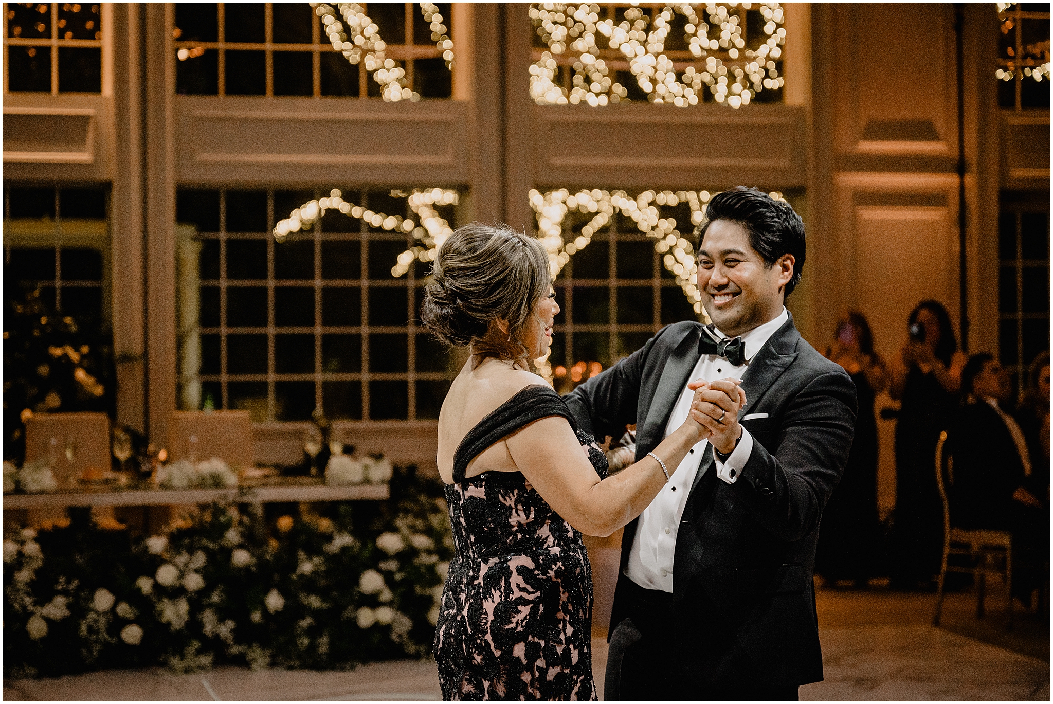 groom and mom smile at each other during New Jersey wedding reception
