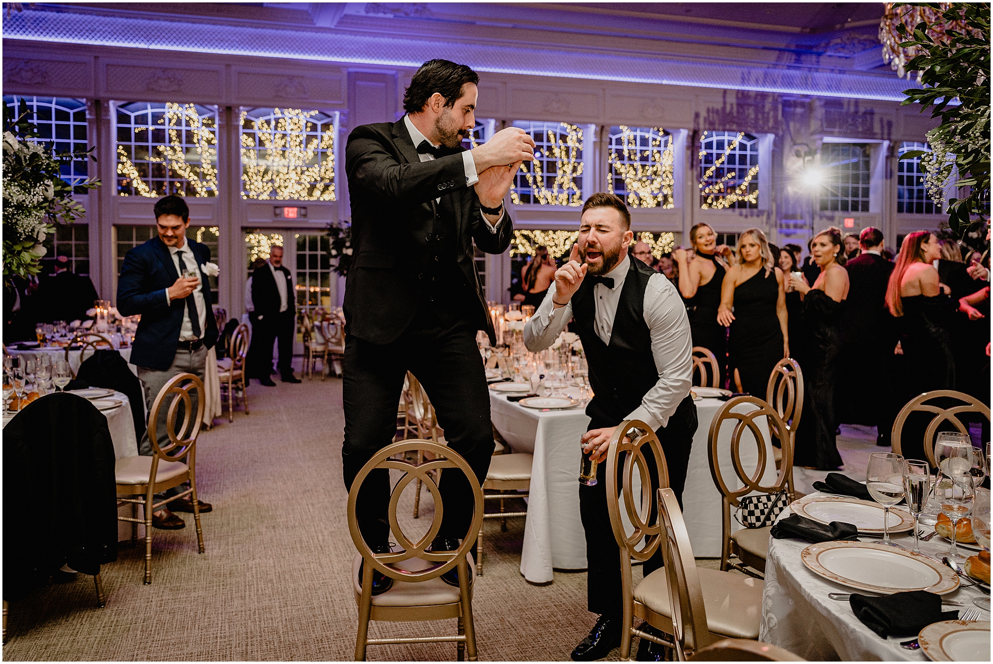 wedding guests dance on chairs during New Jersey wedding reception
