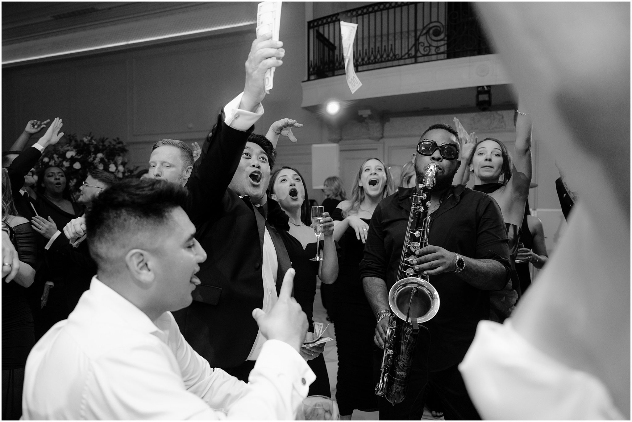 live saxophone player performs while wedding guests dance at New Jersey wedding reception
