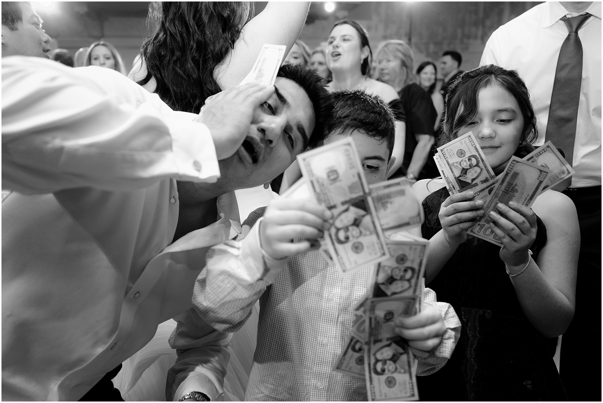 kids hand custom fake money to groom on dance floor during River Vale NJ wedding reception