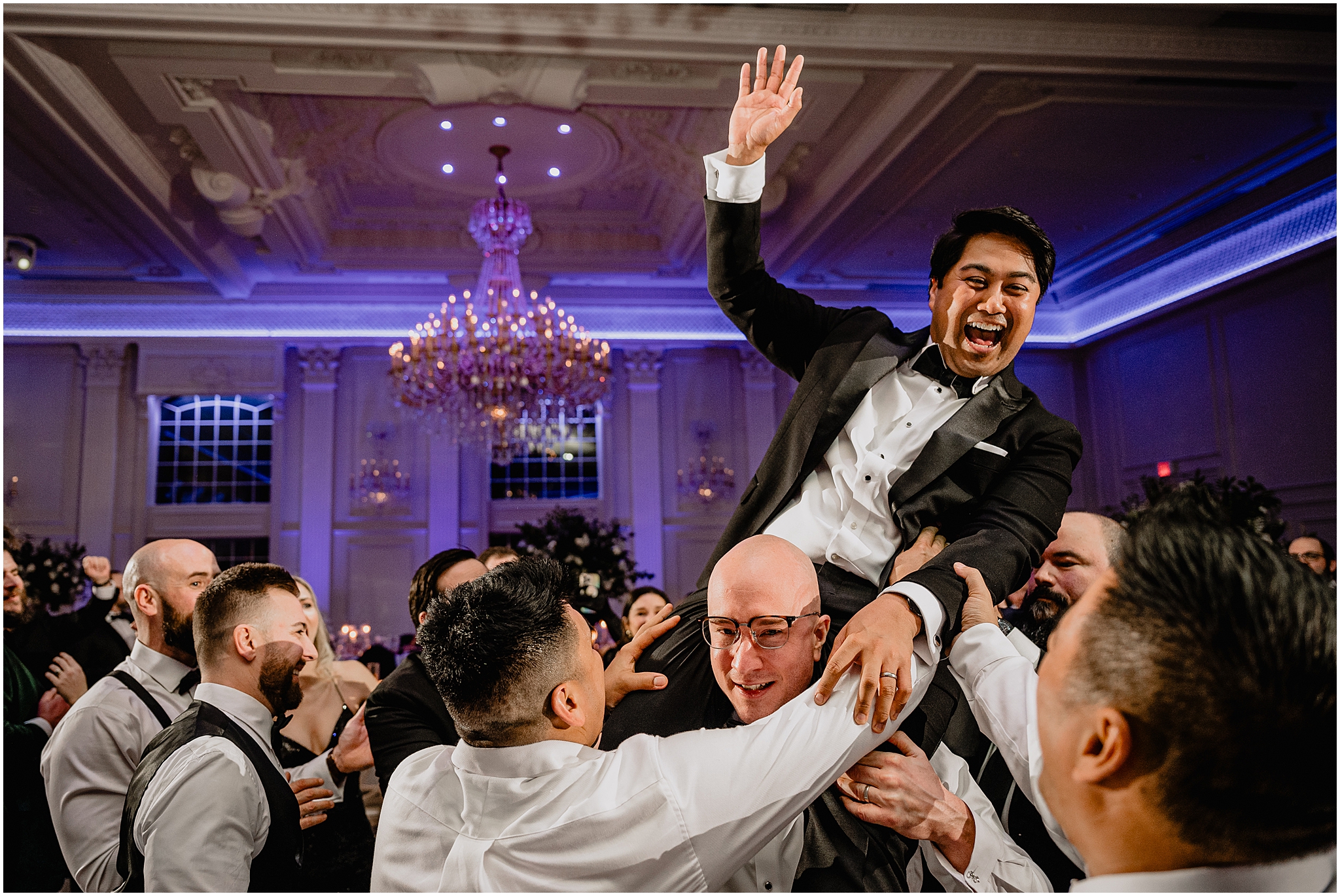 guests lift up groom on their shoulders on dance floor at River Vale NJ wedding reception