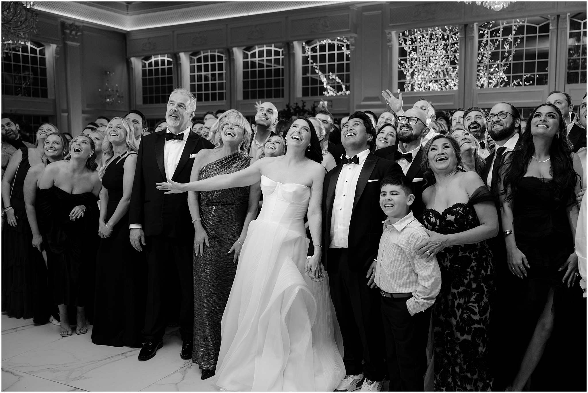 bride and groom grin surrounded by wedding guests during River Vale NJ wedding reception