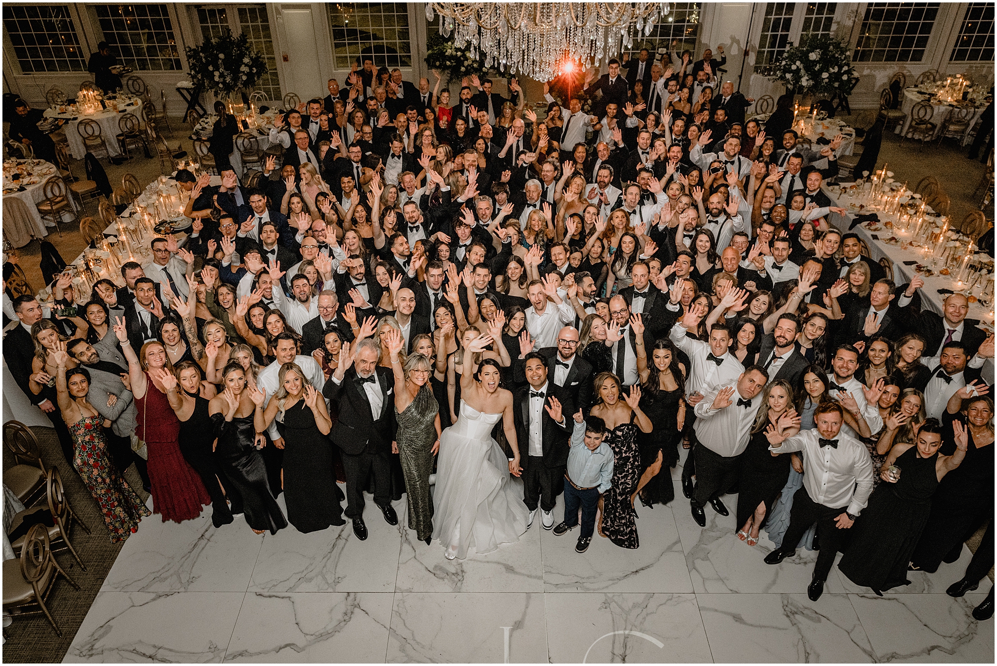 bride and groom wave on dance floor withe wedding guests at the Estate at Florentine Gardens