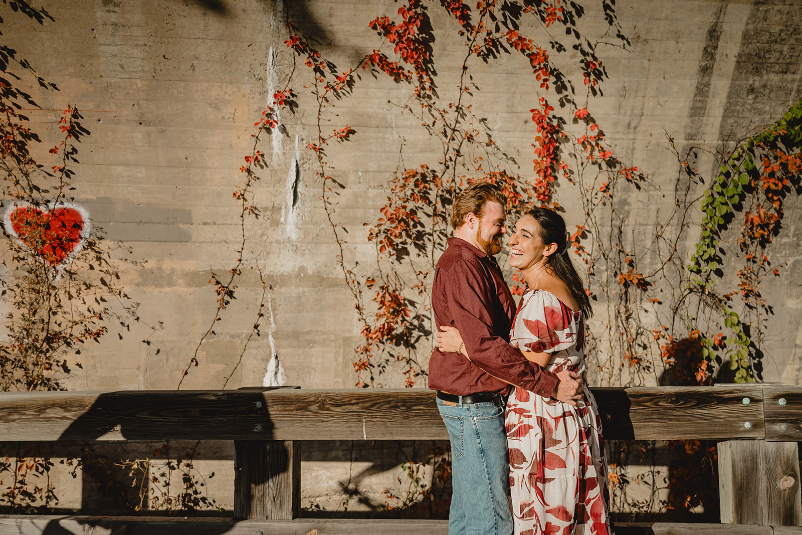 man hugs woman making her laugh during photos in Manayunk