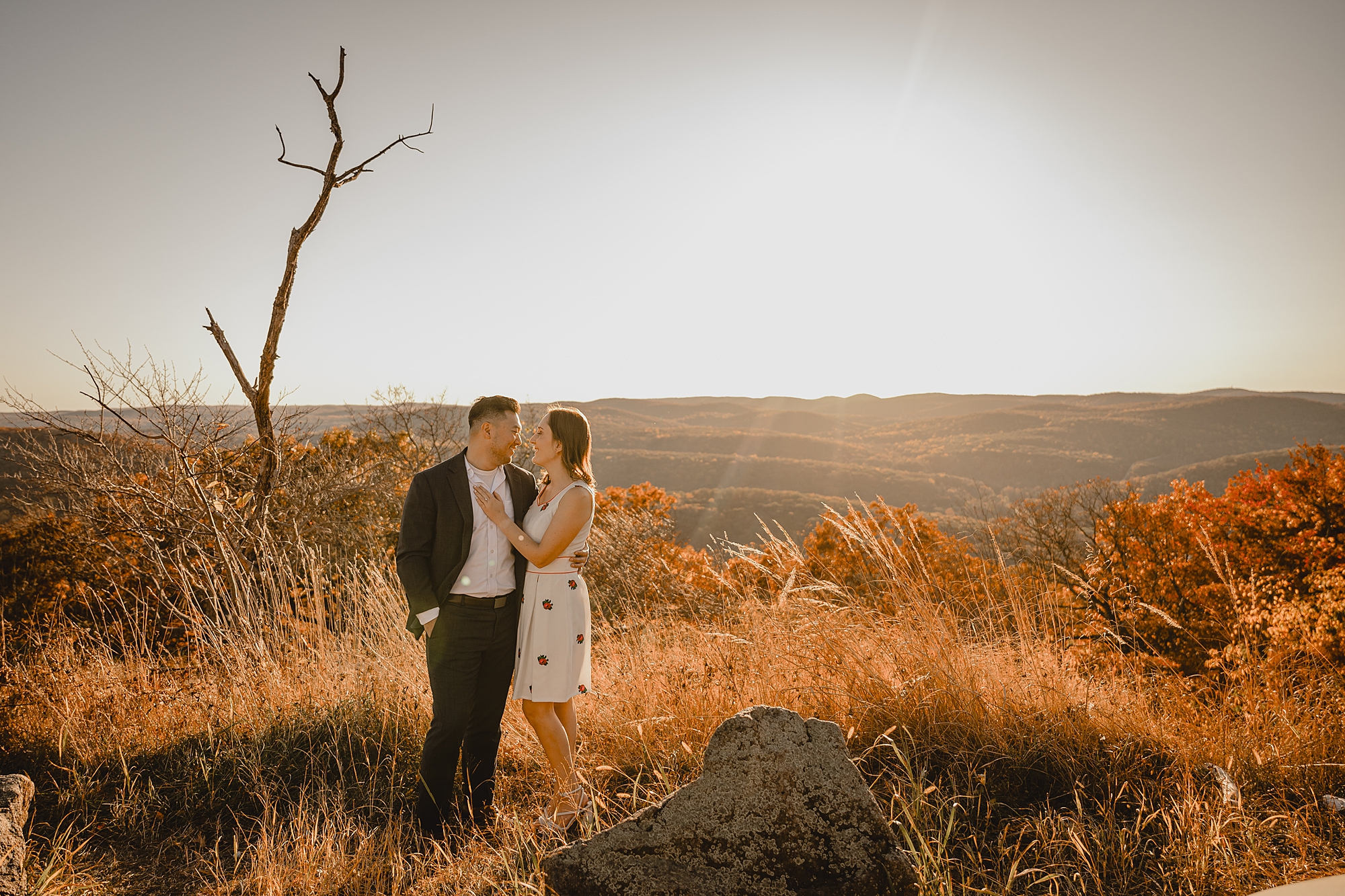 engaged couple hugs during fall engagement session on Bear Mountain in the Hudson Valley