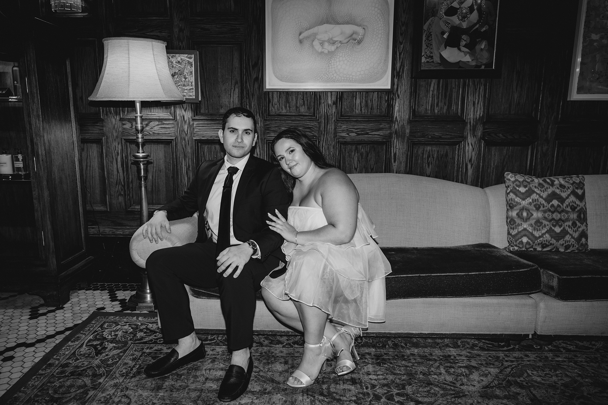 engaged couple sits on couch inside the Beekman Hotel