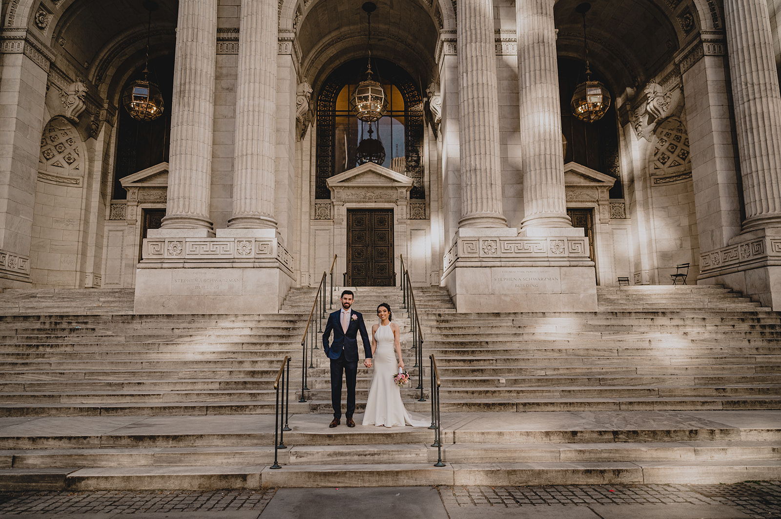 couple poses on stairs outside NYC courthouse for elopement