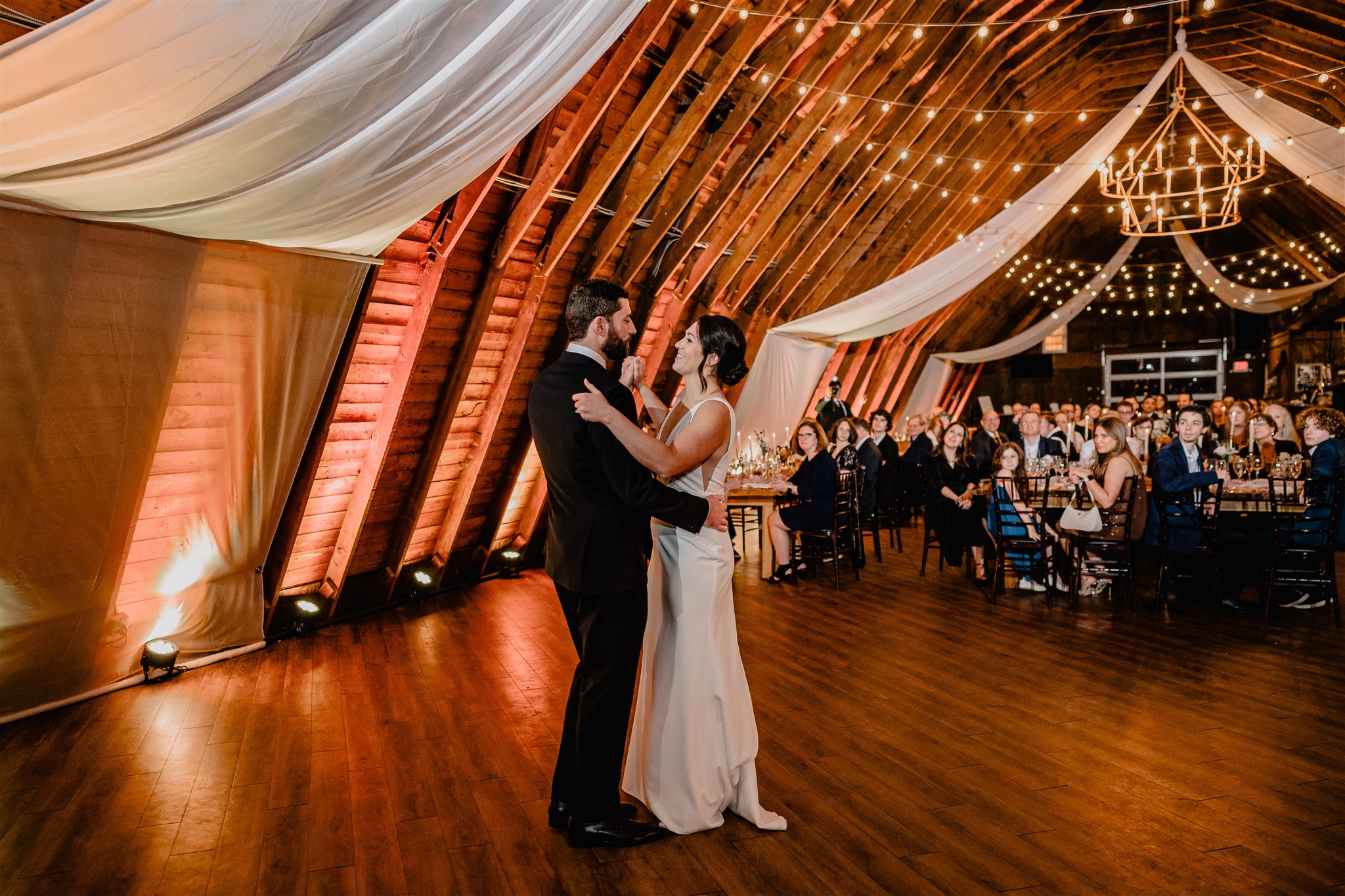 bride and groom dance in barn reception
