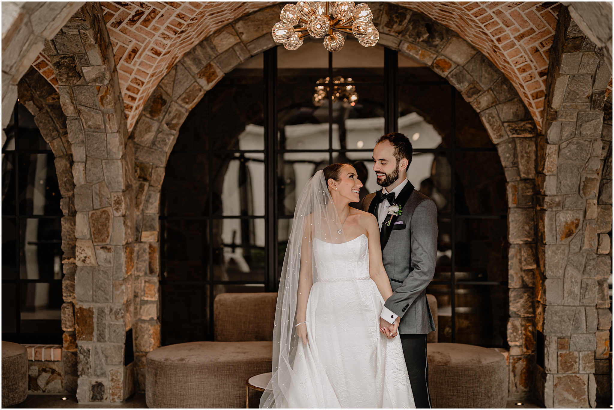 Couple smiling at each other at their wedding day at Perona Farms.