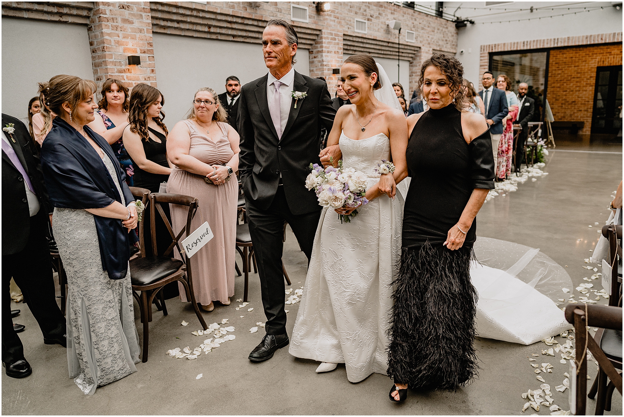 bride walking down the aisle with her parents at perona farms
