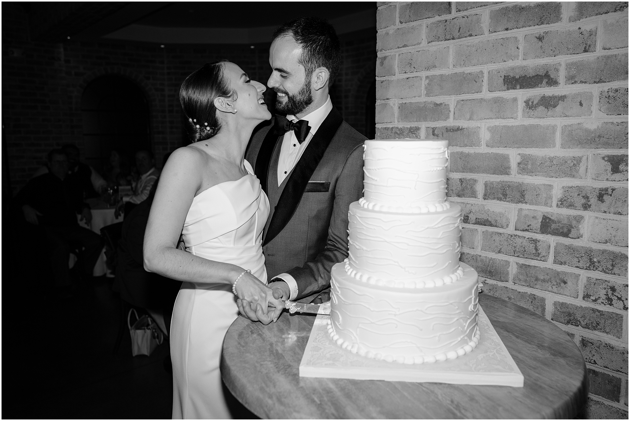 Couple slicing the cake at Wedding at Perona Farms