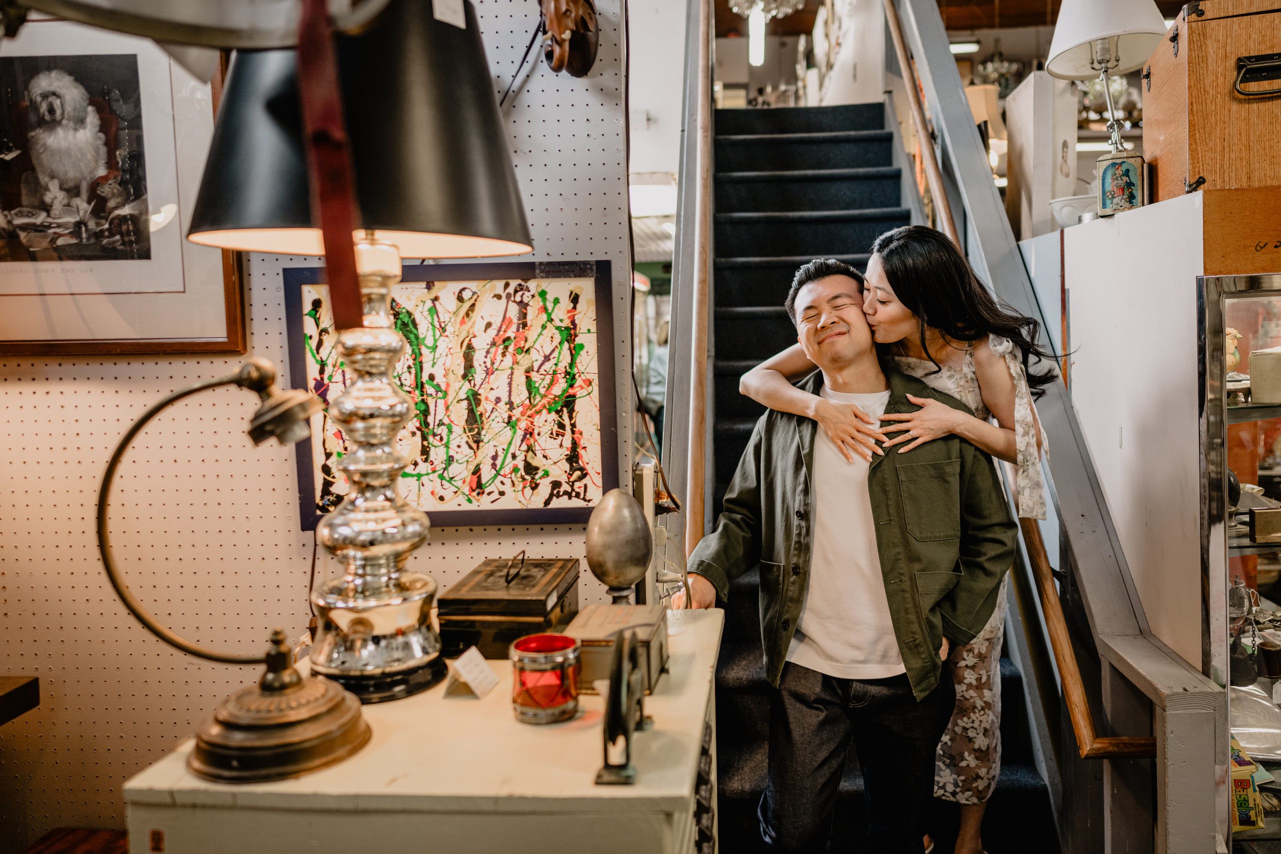 couple by the stairs of the antique shop