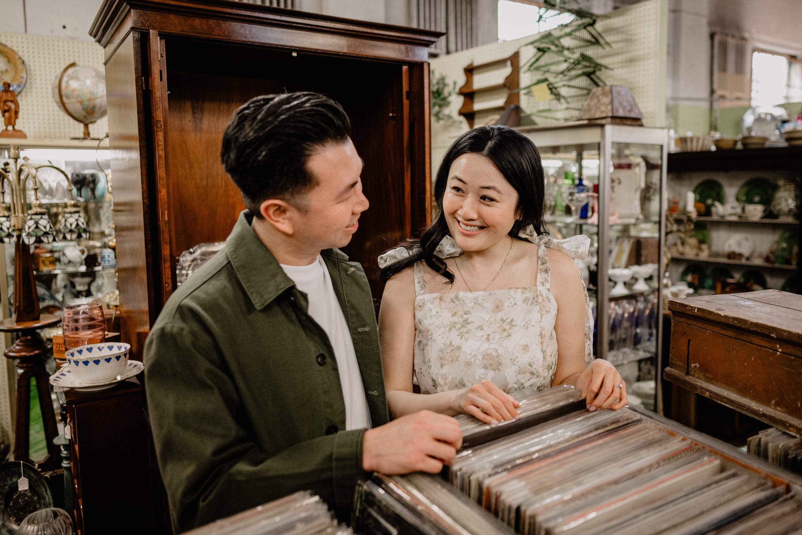 couple looking on some records at the antique shop