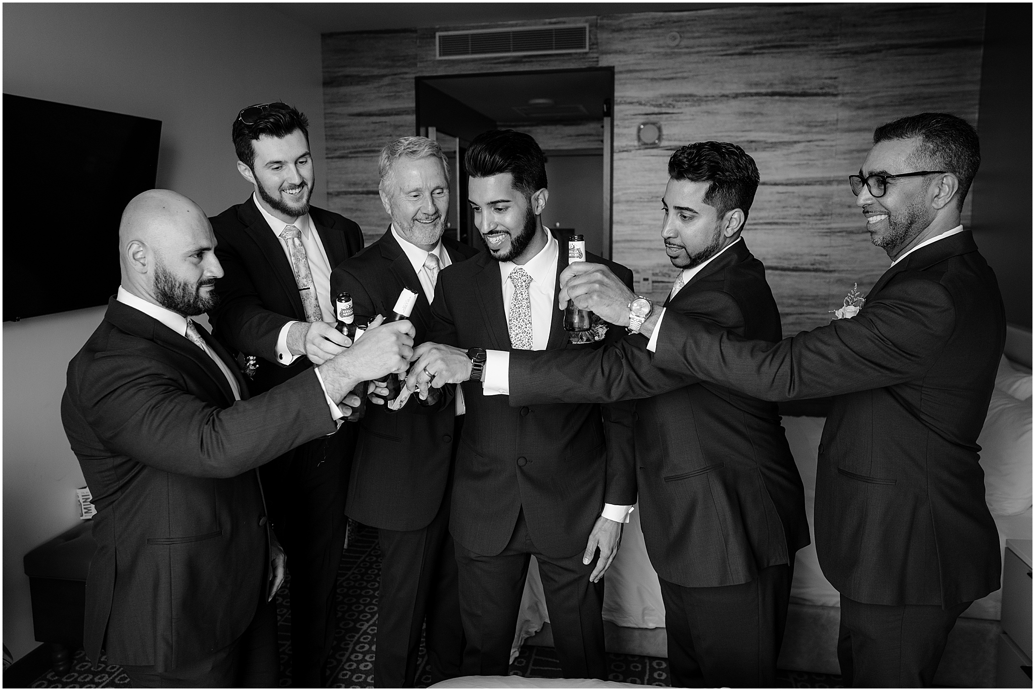 Groom and groomsmen having a toast before the Unforgettable Porta Montclair Wedding.