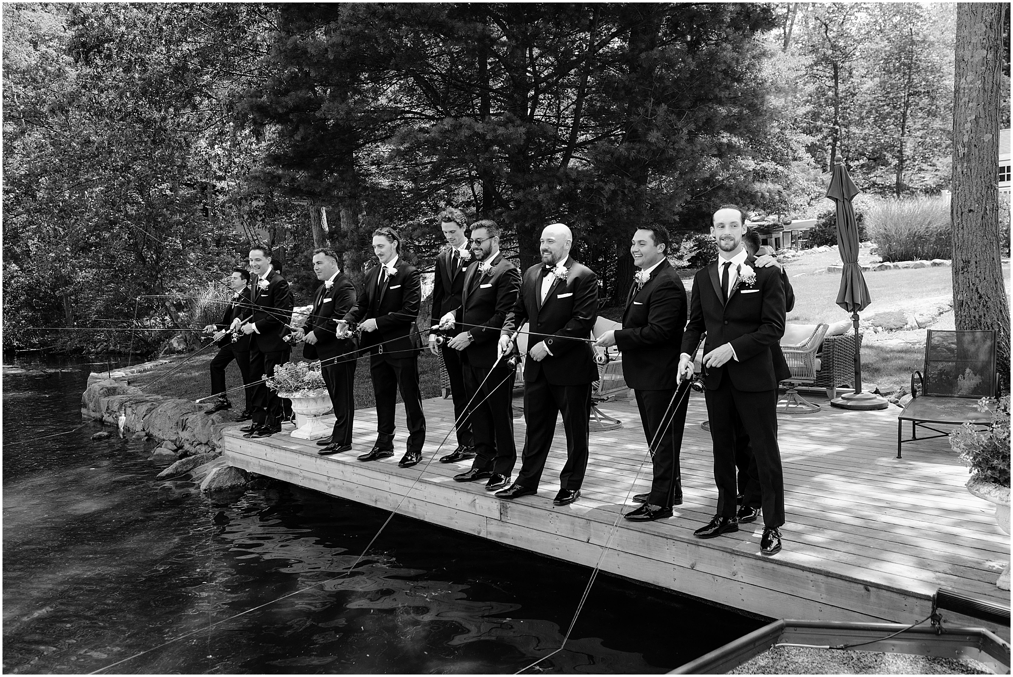 Groom with his groomsmen fishing by a dock before the Summer Park Chateau Wedding, capturing a relaxed and unique moment.