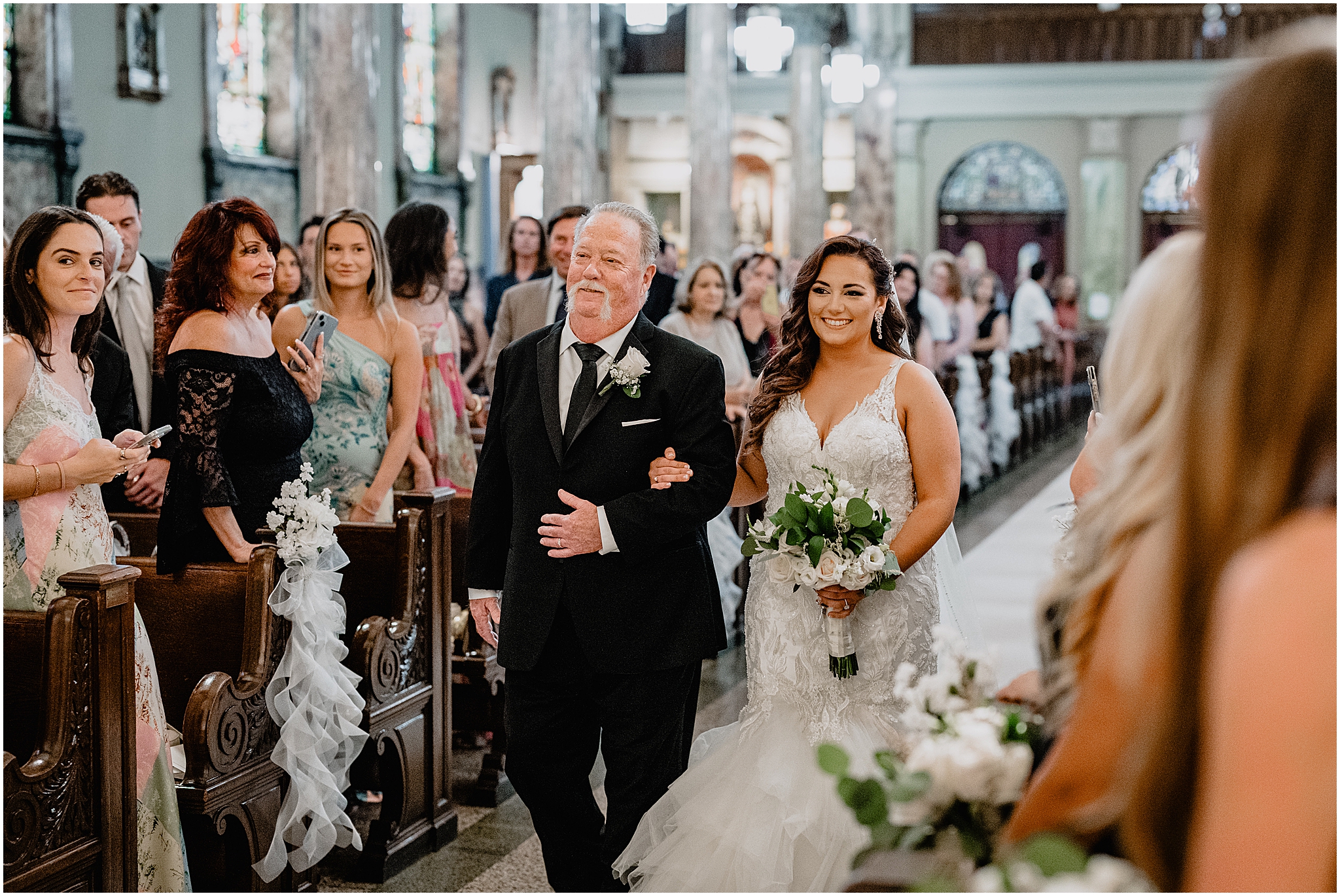 Bride walking down the aisle with her father during her Summer Park Chateau Wedding ceremony, capturing an emotional and timeless moment.