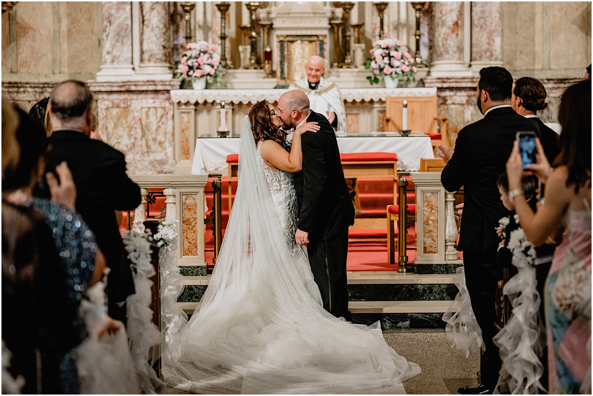 Couple sharing their first kiss at the altar during their Summer Park Chateau Wedding, marking the start of their married life.