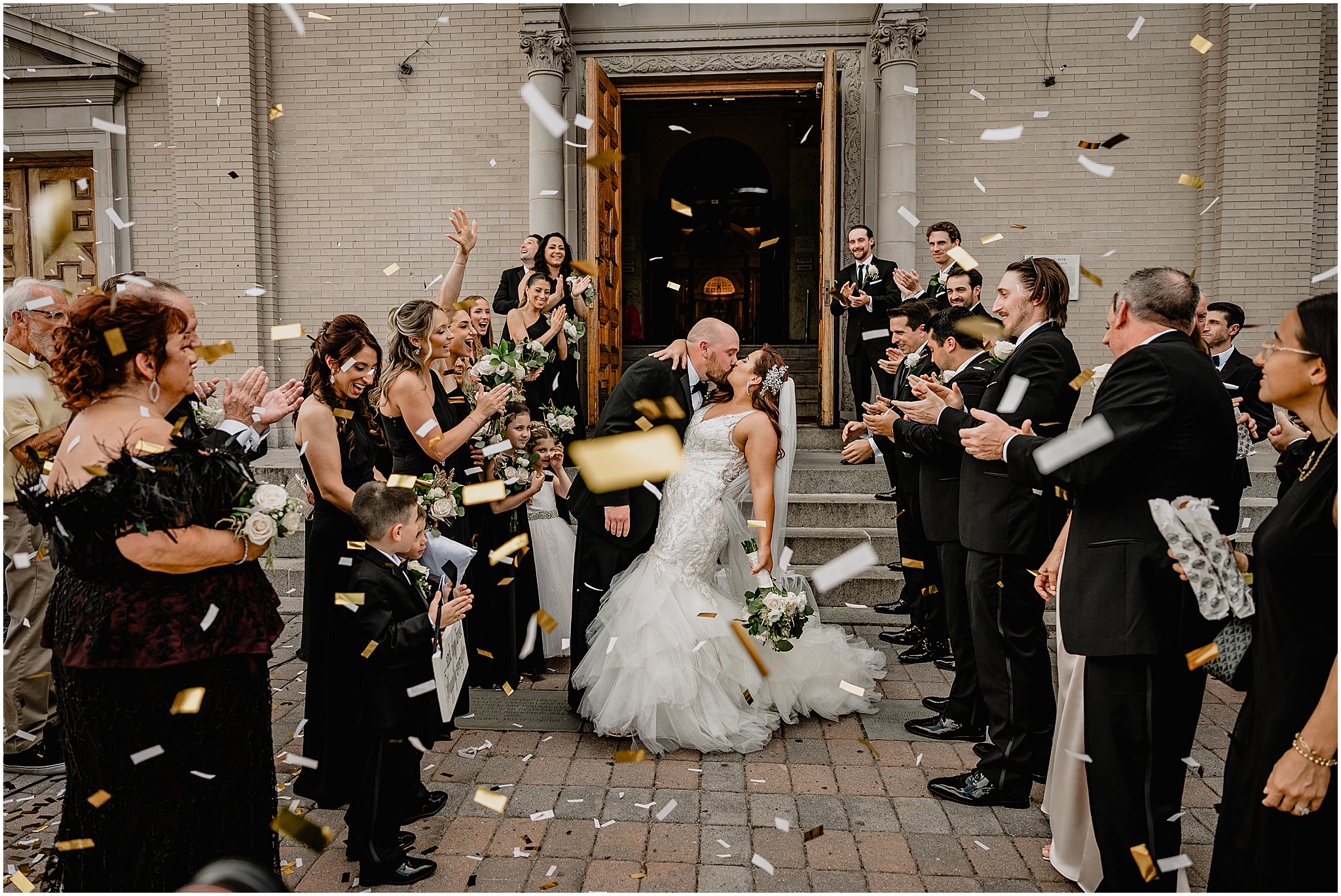 Couple sharing their first kiss during their Summer Park Chateau Wedding, marking the start of their married life.