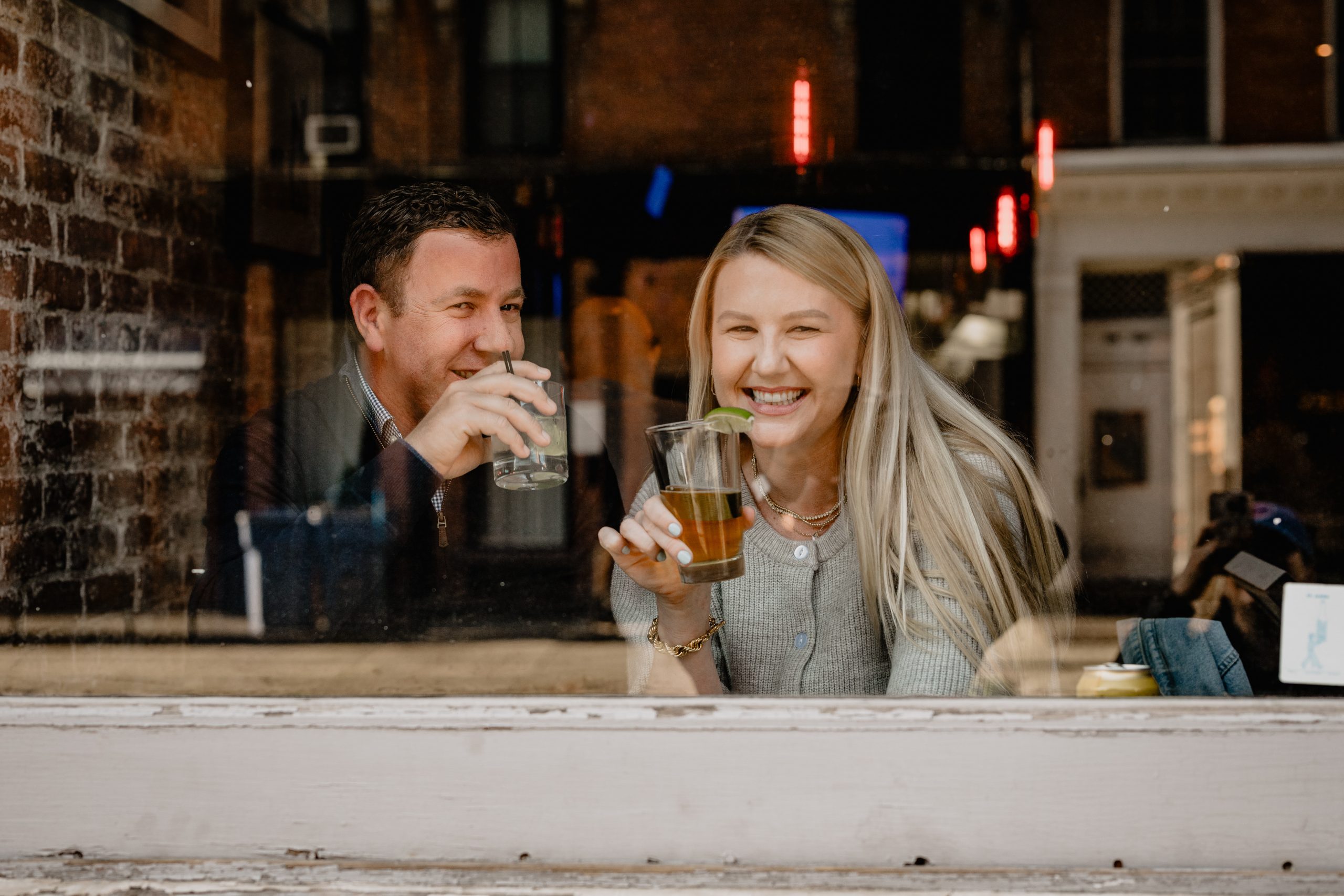 Couple enjoying drinks together in a bar during their Tribeca NYC engagement session.