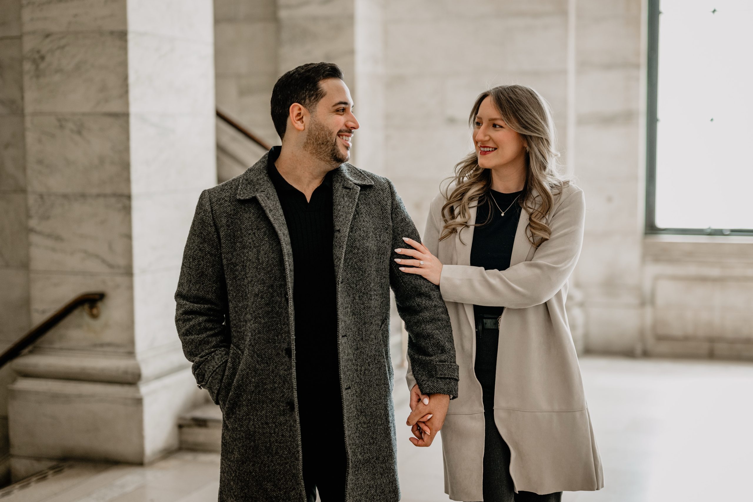 Couple walking hand-in-hand at their New York Public Library Engagements and Weddings