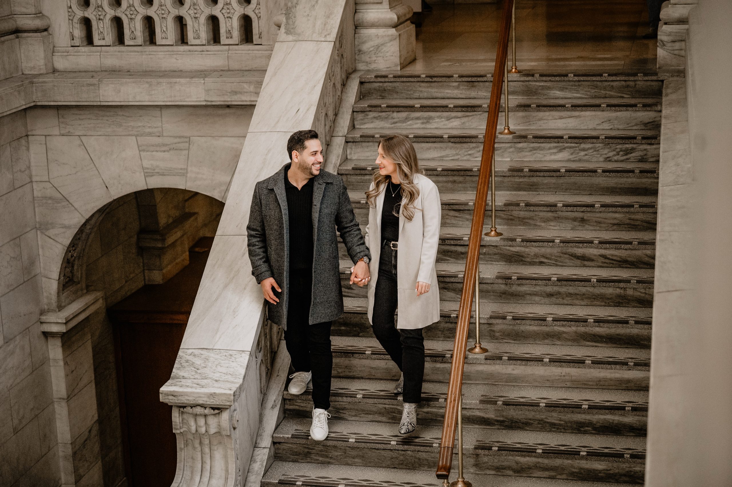 Couple walking down the stairs at New York Public Library Engagements and Weddings