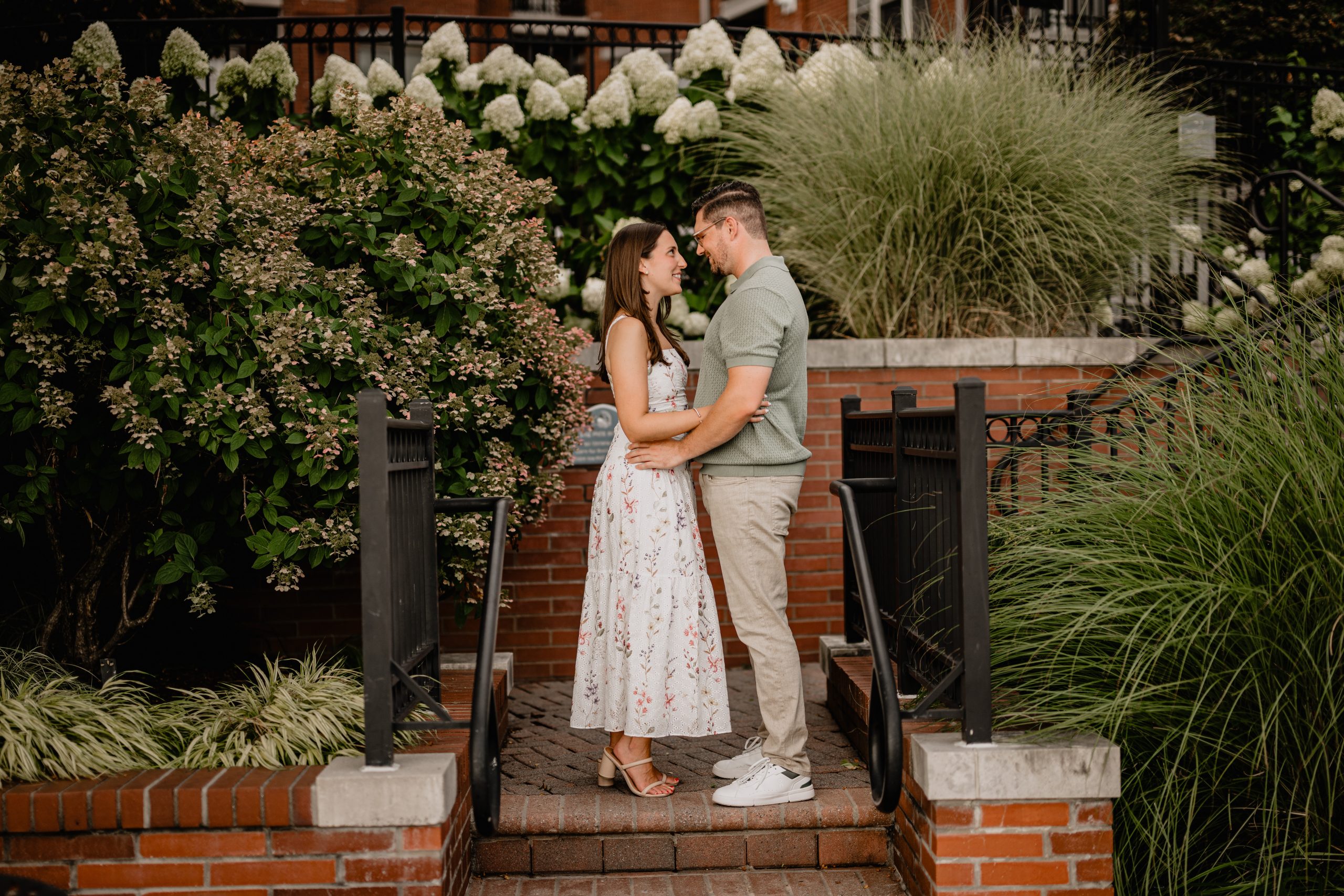 Couple looking intently at each other during their Jersey City Engagement at Paulus Hook.