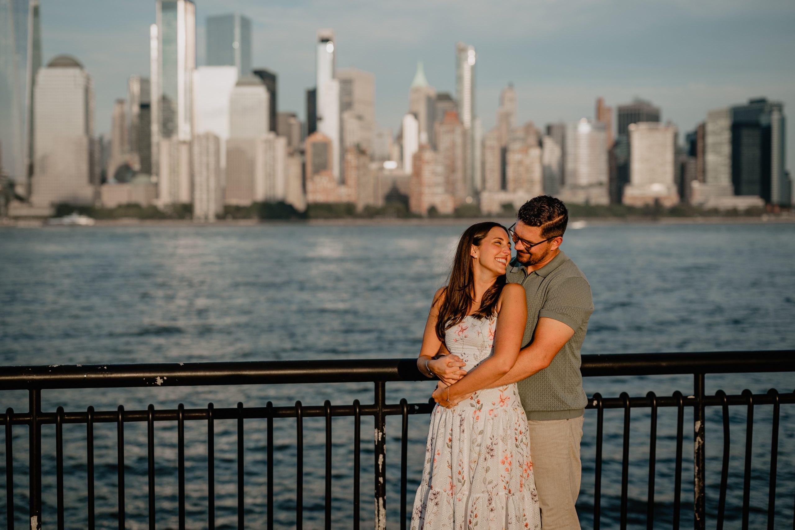 Couple smiling and showing their love during their Jersey City Engagement at Paulus Hook.
