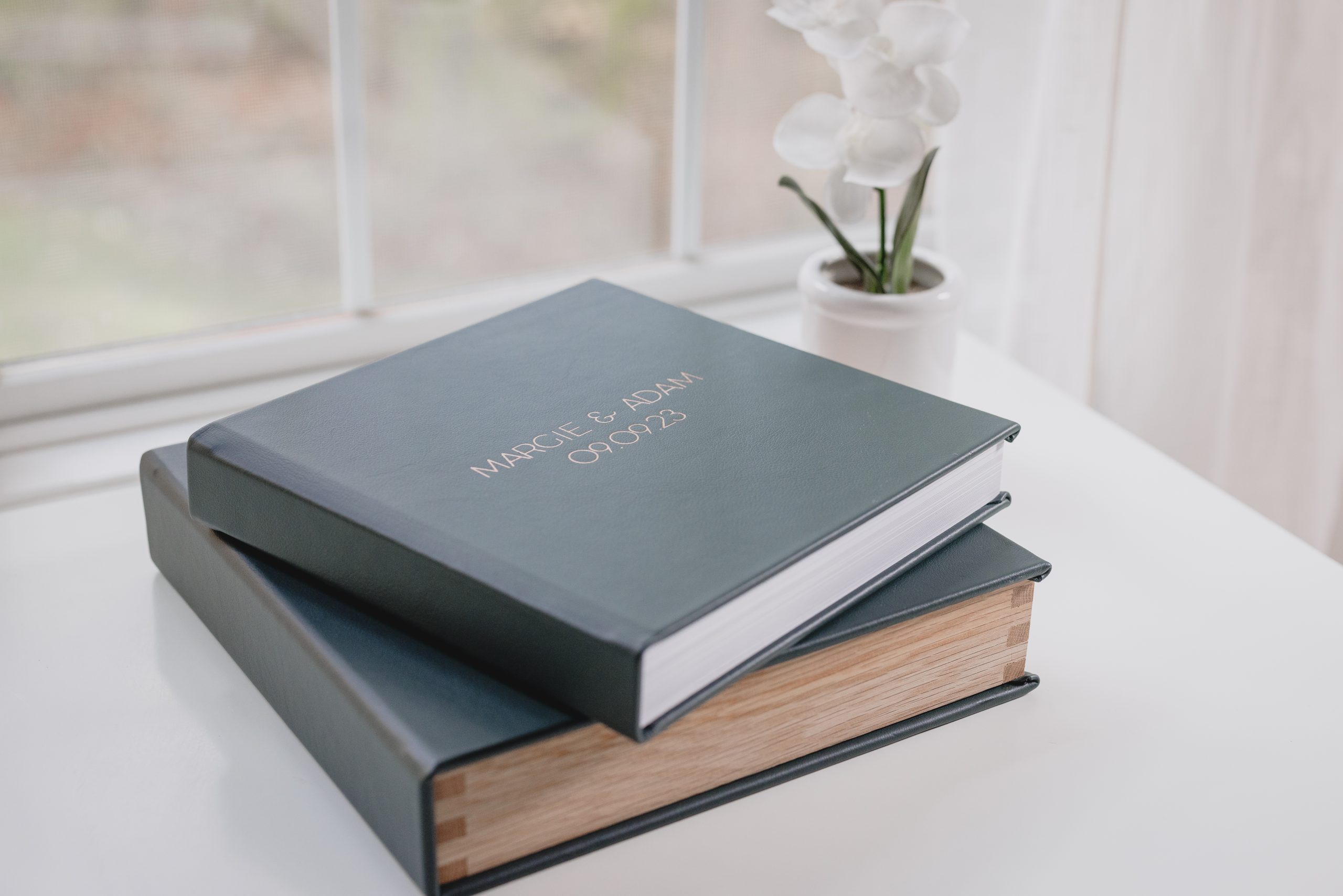 Stack of elegant wedding albums with custom covers, designed by a New Jersey wedding photographer.