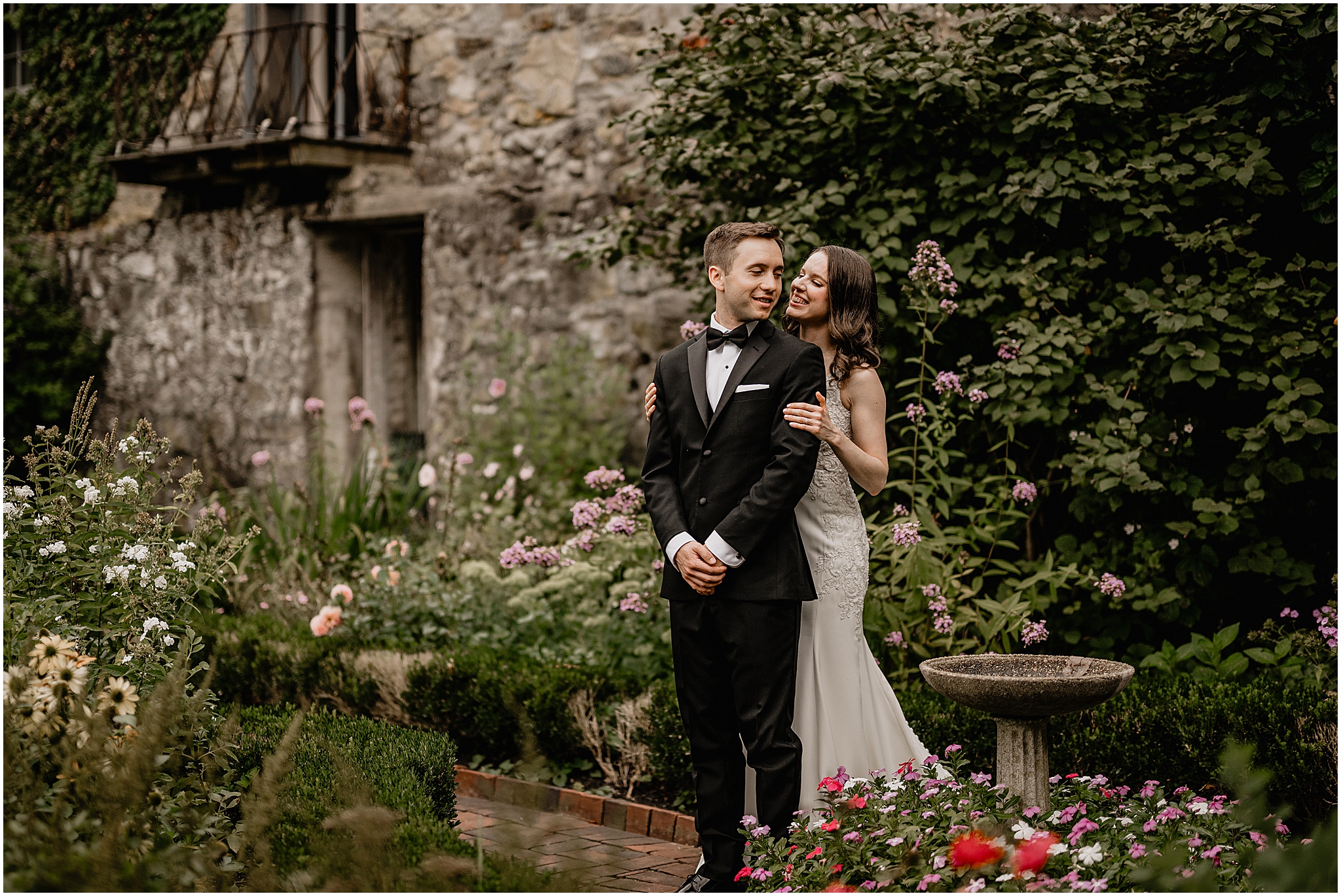 Bride hugging her groom from behind during their Summer Crossed Keys Estate wedding.