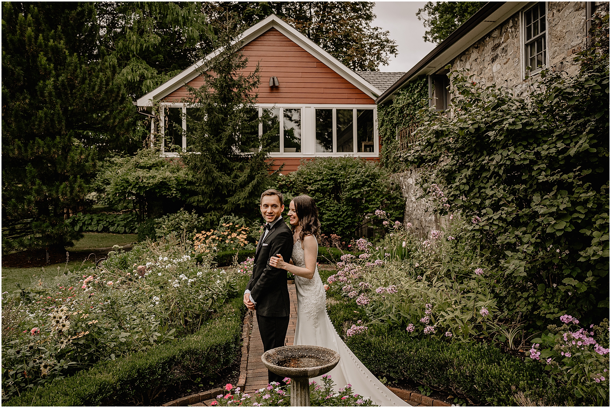 Bride hugging her groom from behind during their Summer Crossed Keys Estate wedding.