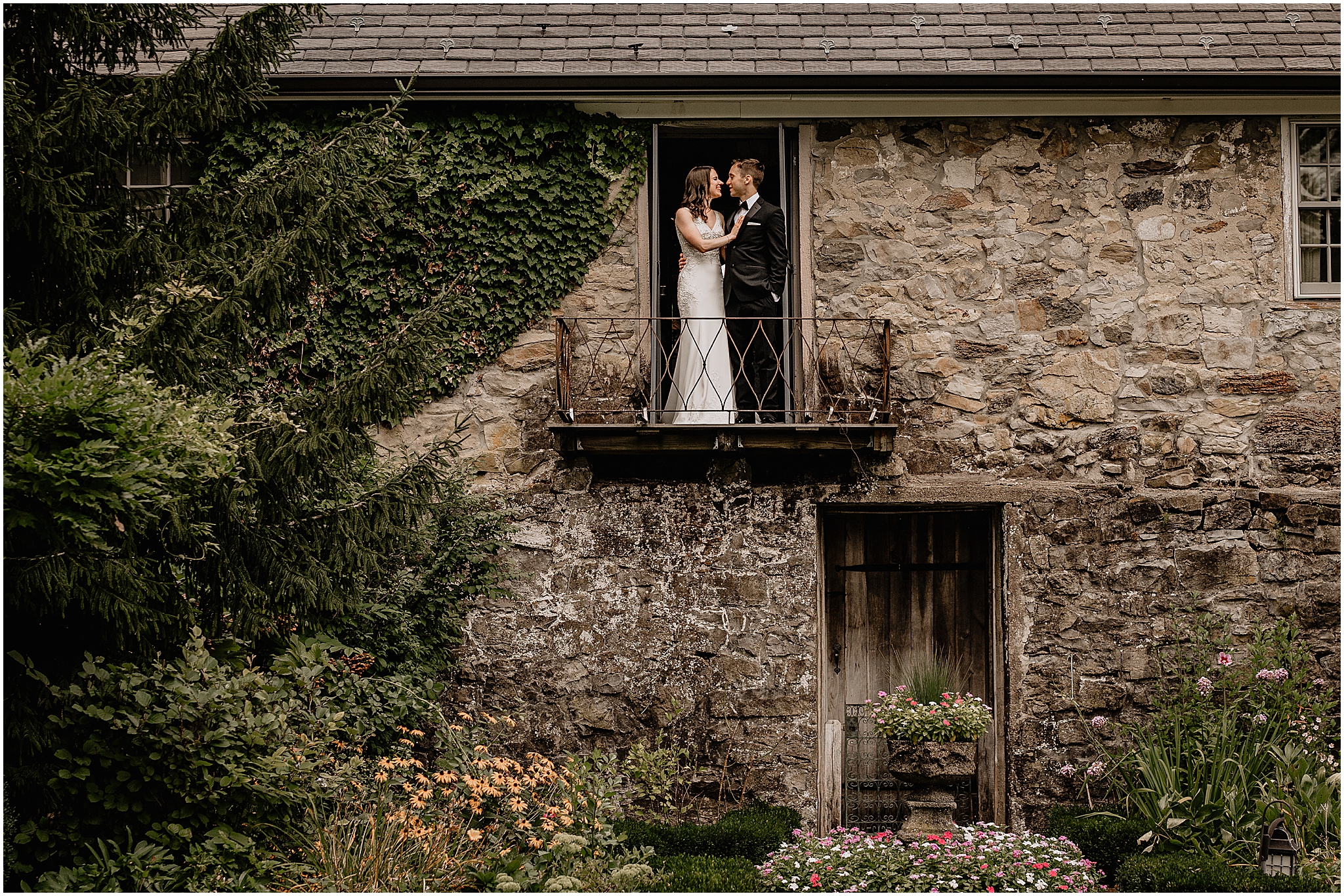 Couple on the balcony during their Summer Crossed Keys Estate wedding.