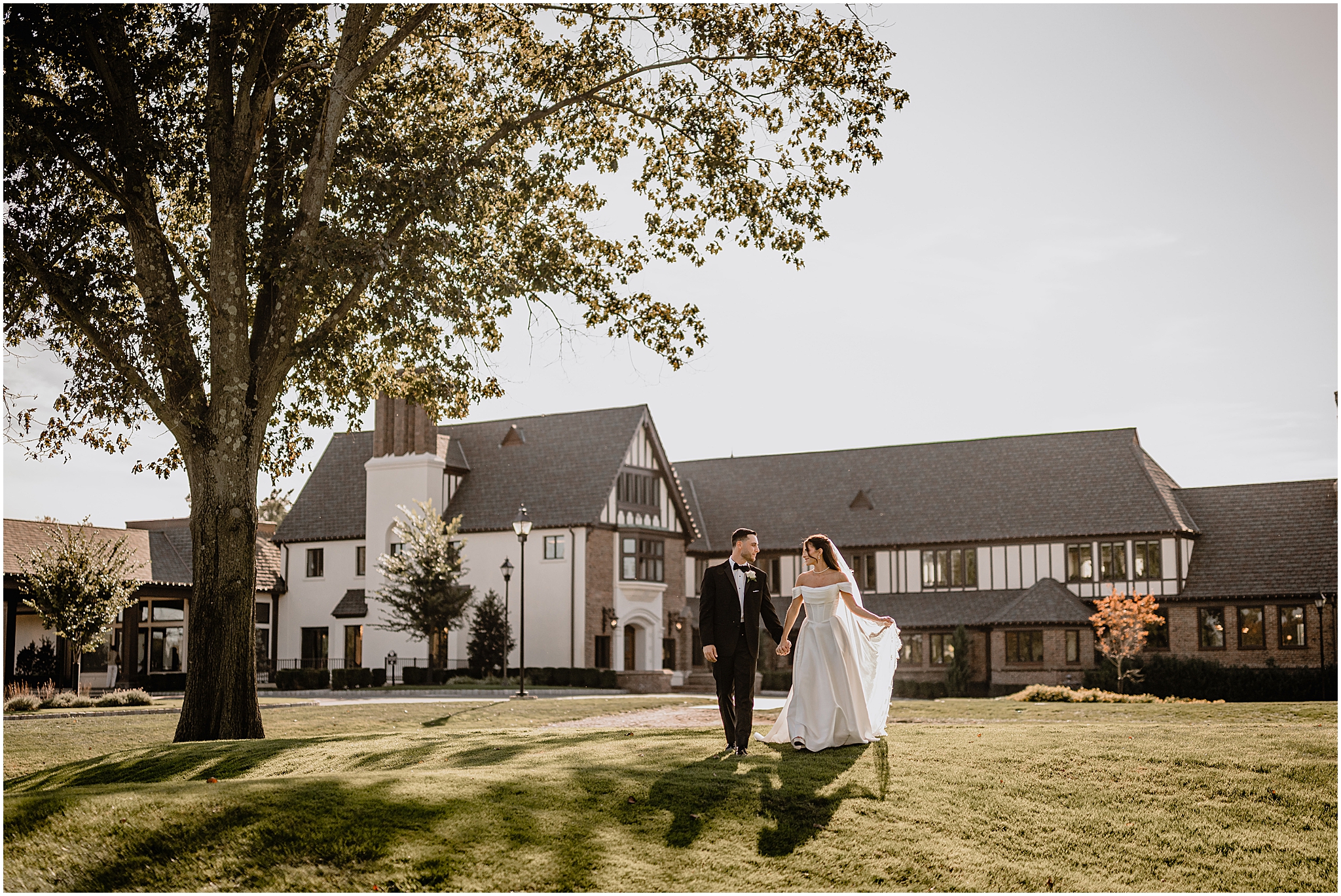 Bride and groom walking hand in hand in the sunlight during their Tillinghouse Wedding portraits.
