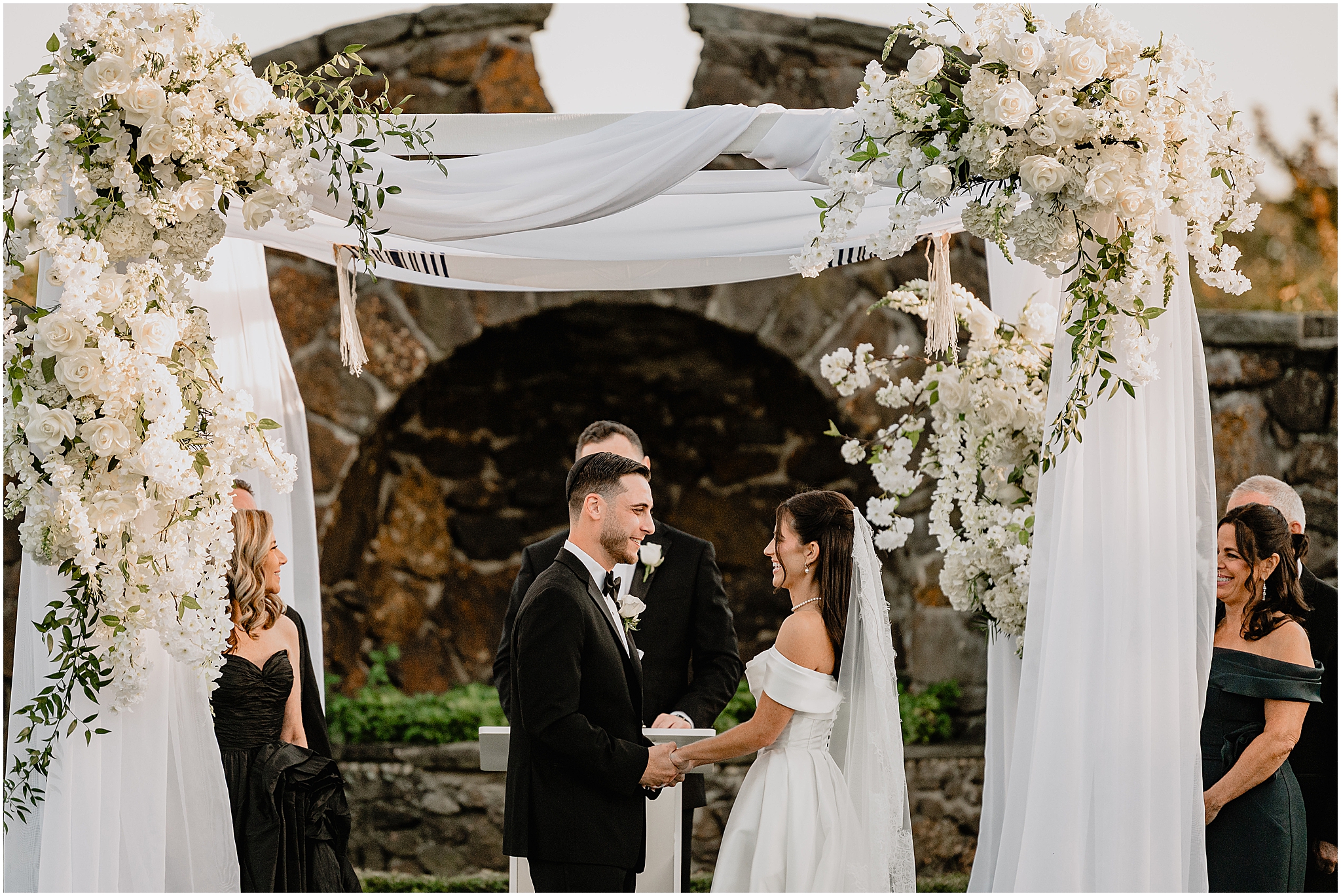 Couple at the altar holding hands during their Tillinghouse Wedding.