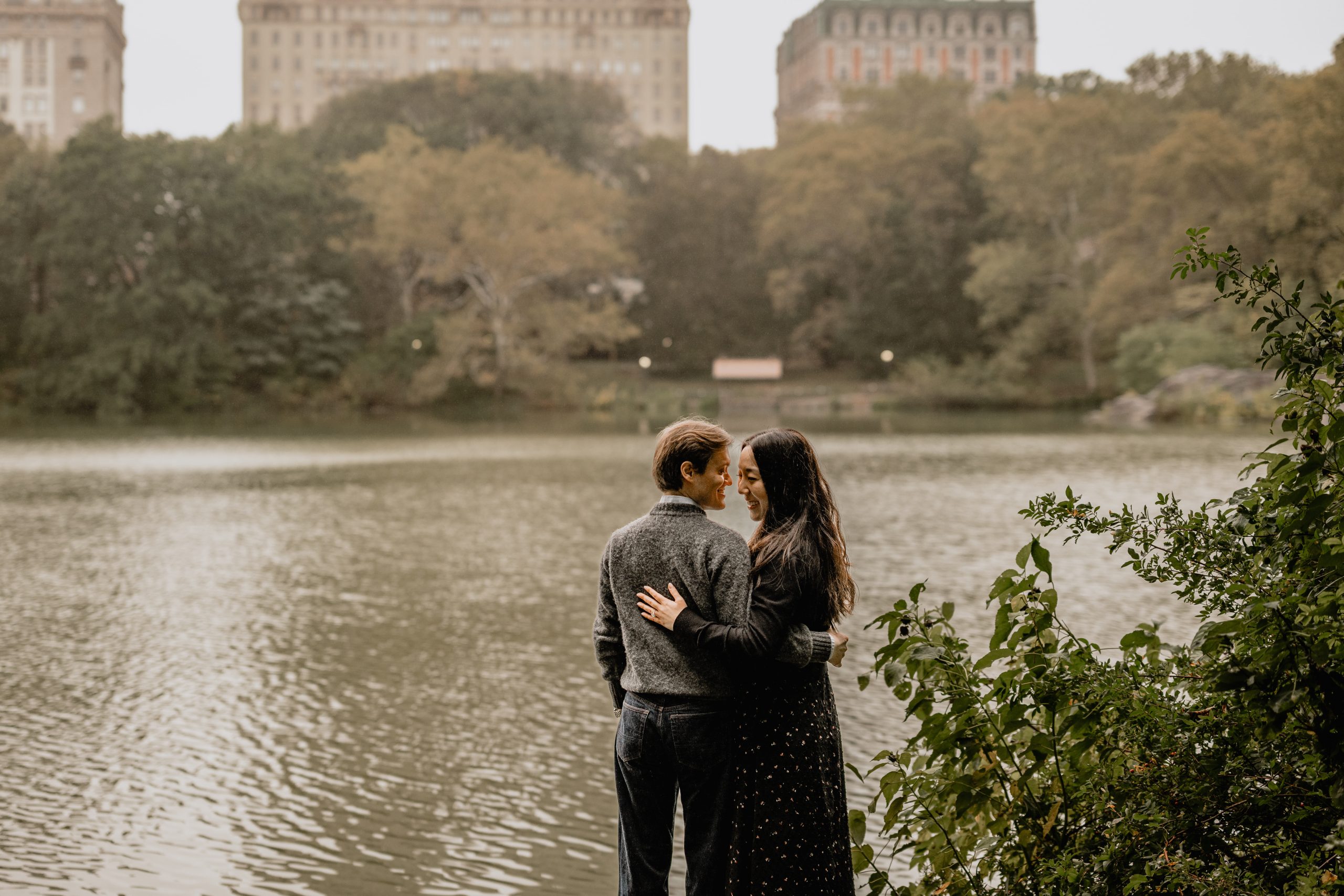 Kimberly and Peter share a sweet moment by the water during their fall engagement session at Central Park.