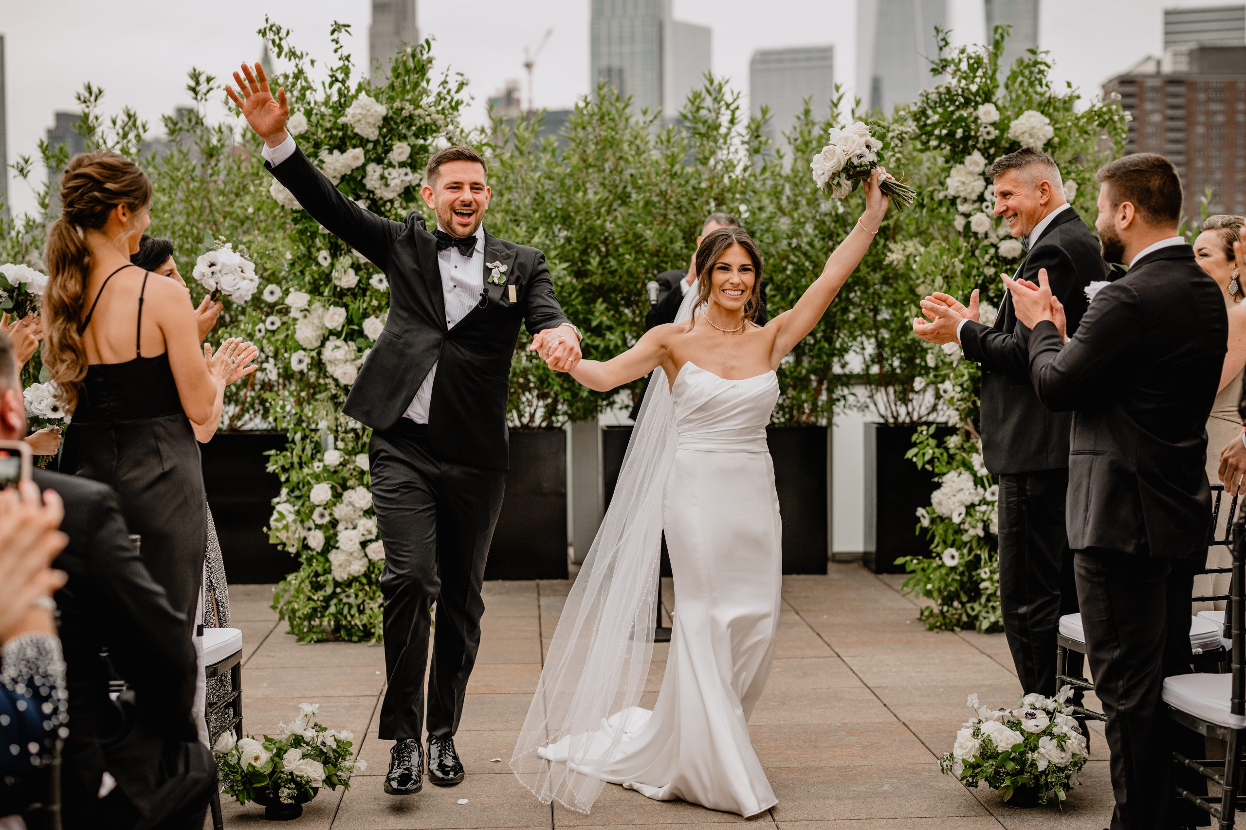 couple walking down the aisle while holding hands during weddings at Tribeca Rooftop in New York City