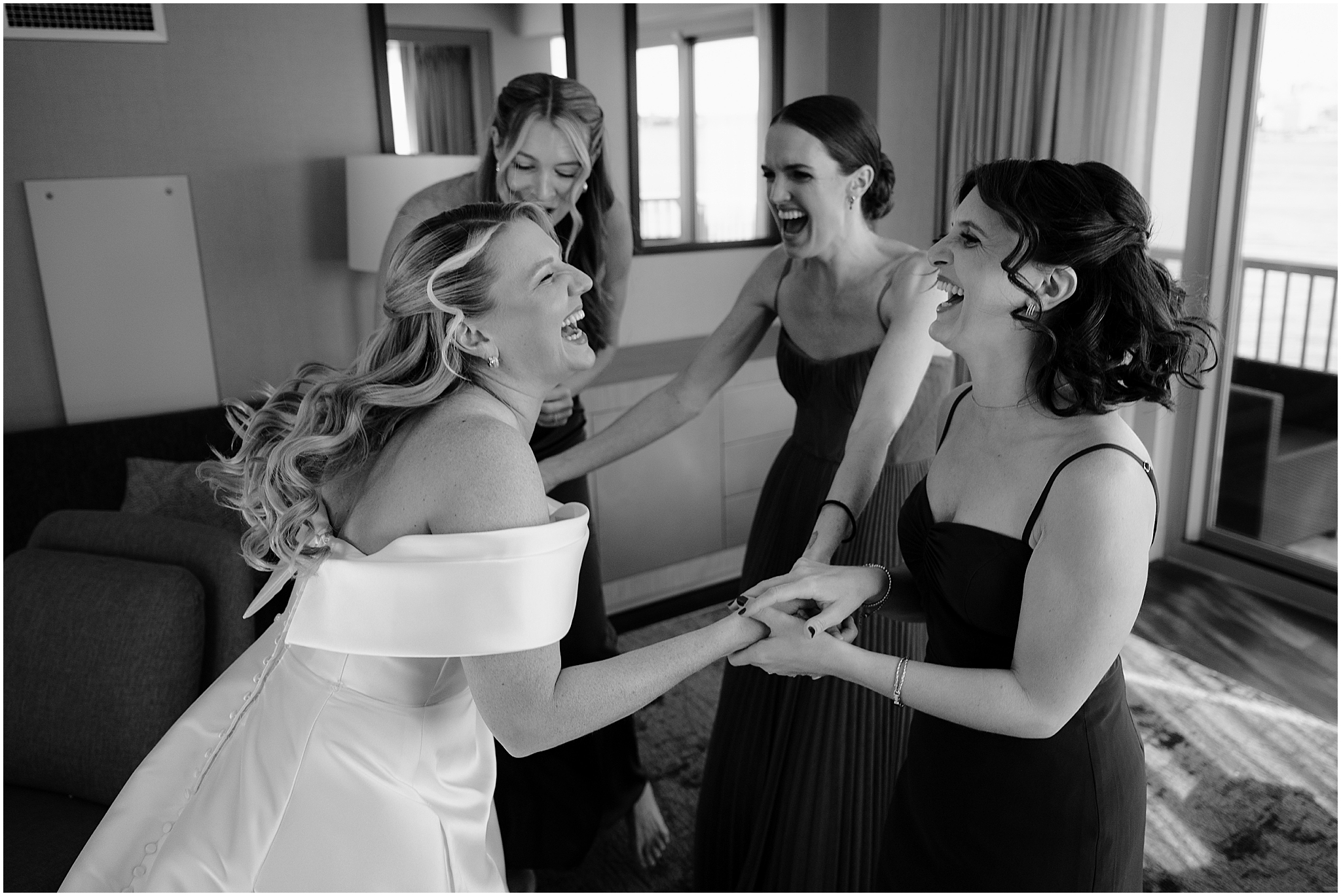 Bride’s first look with her bridesmaids, sharing an emotional and joyful moment before the ceremony at their Colorful Fall Wedding at Liberty House.
