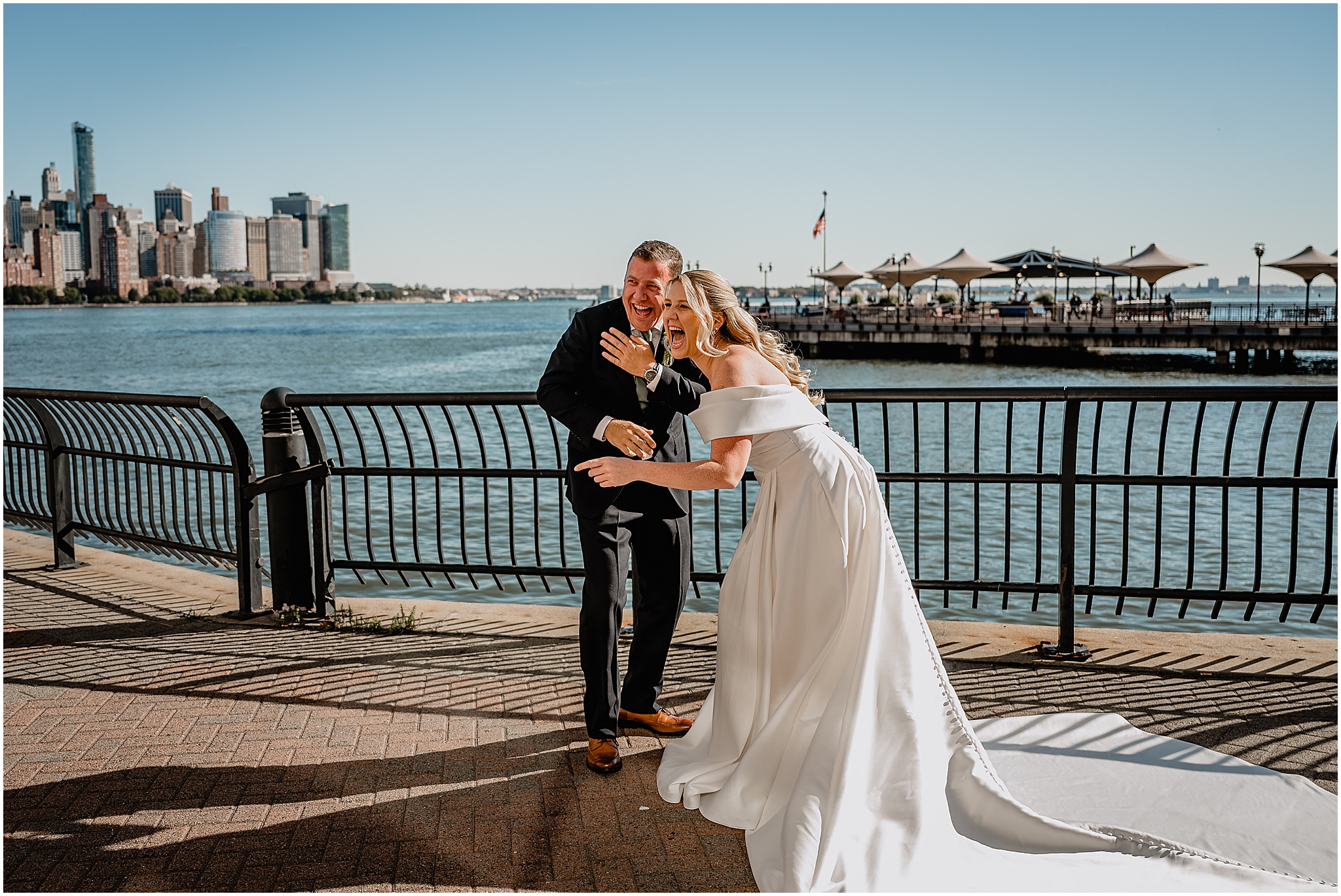Couple's first look and laughter with the stunning NYC skyline as the backdrop at their Colorful Fall Wedding at Liberty House.