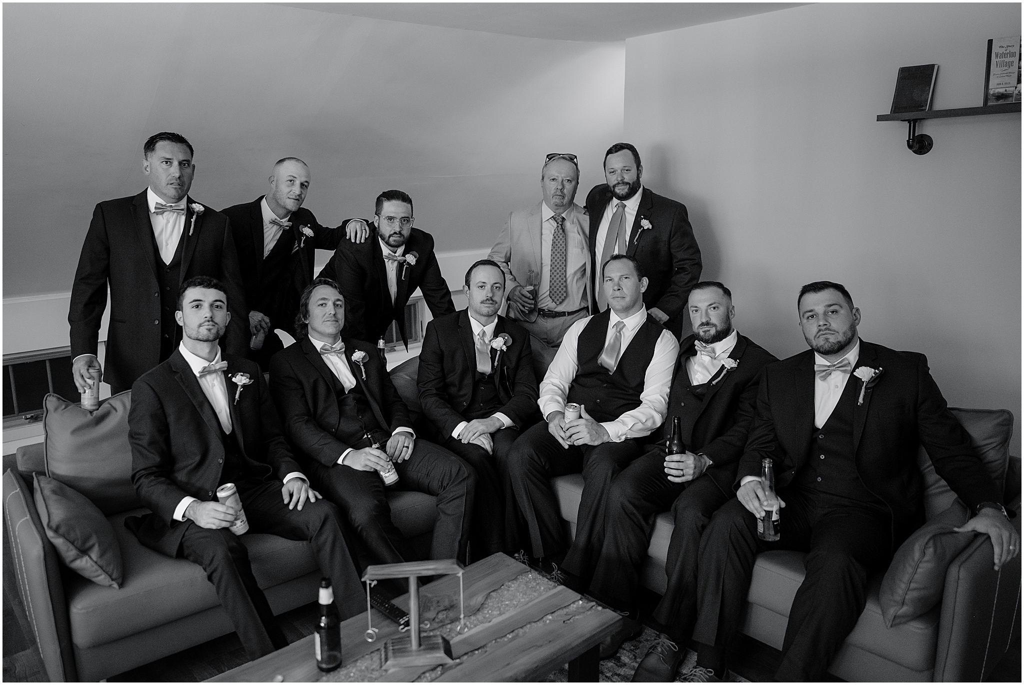Groom and the groom's men celebrating with champagne during their summer wedding at Waterloo Village.