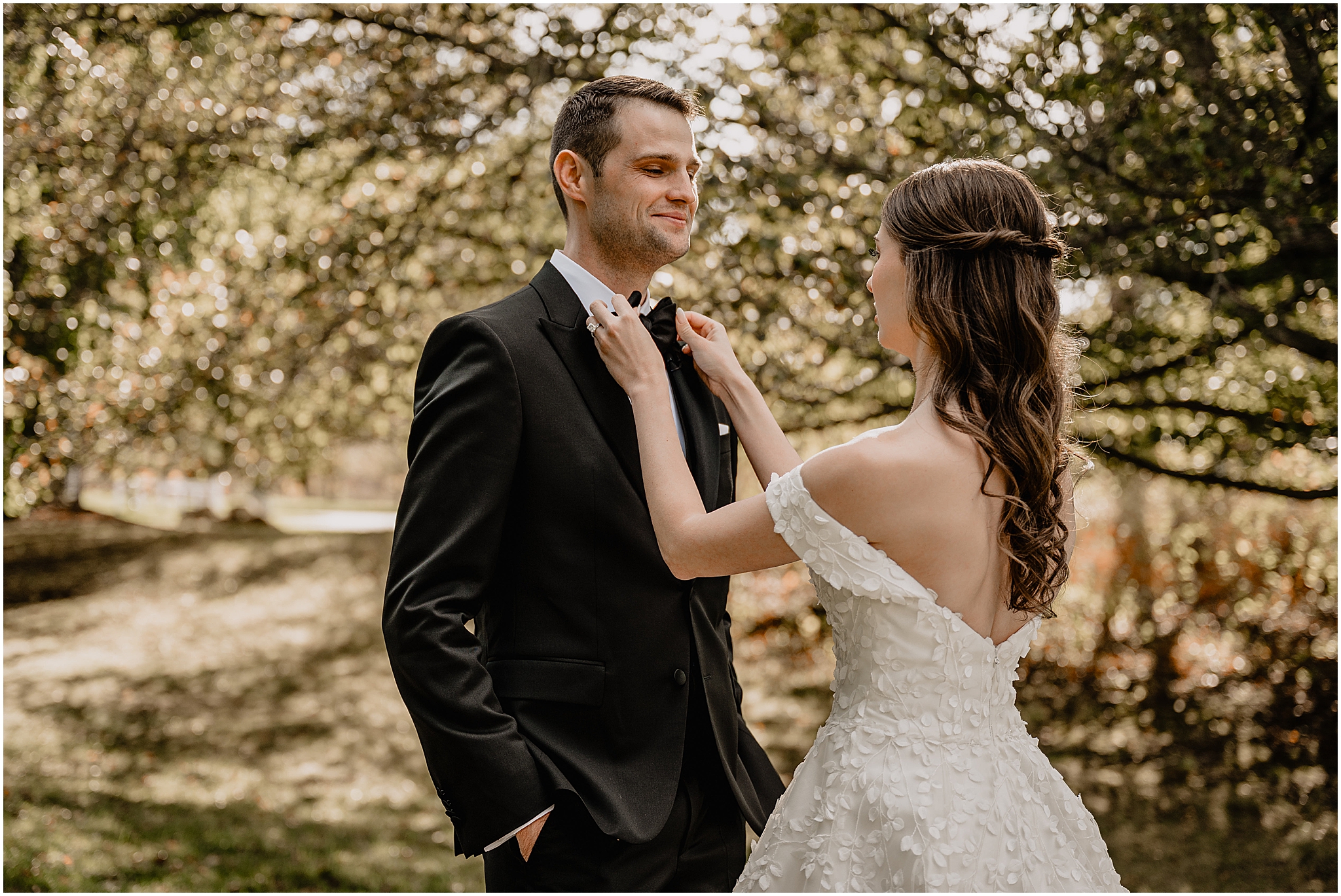 Bride fixing her husband's bow tie before their fall wedding at Crossed Keys Estate.
