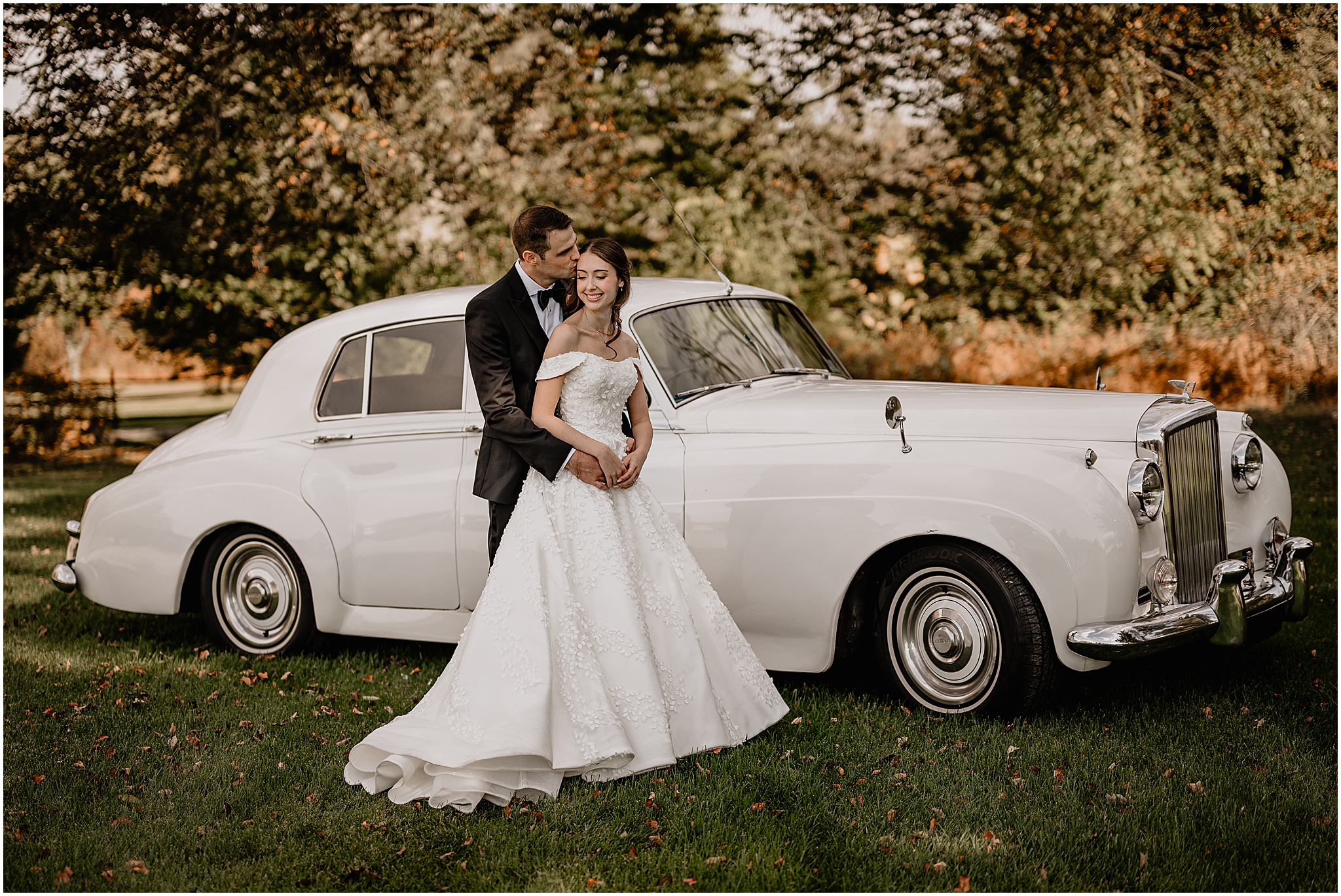 Couple portraits with the vintage car behind them before their fall wedding at Crossed Keys Estate.