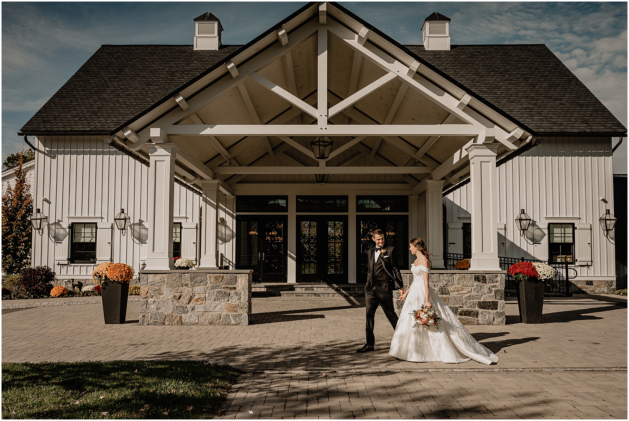 Couple walking hand-in-hand before their fall wedding at Crossed Keys Estate.