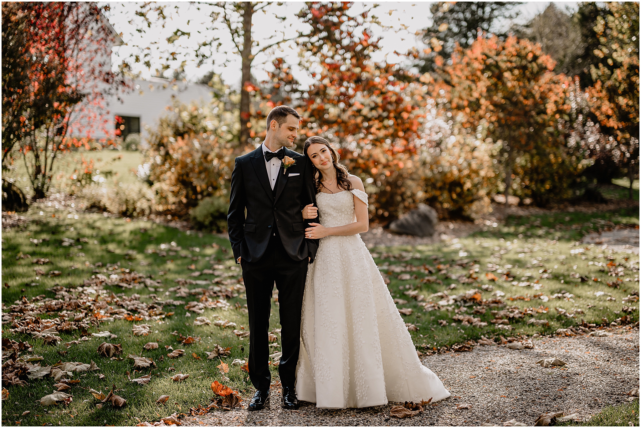 Couple portraits surrounded by autumn leaves before their fall wedding at Crossed Keys Estate.