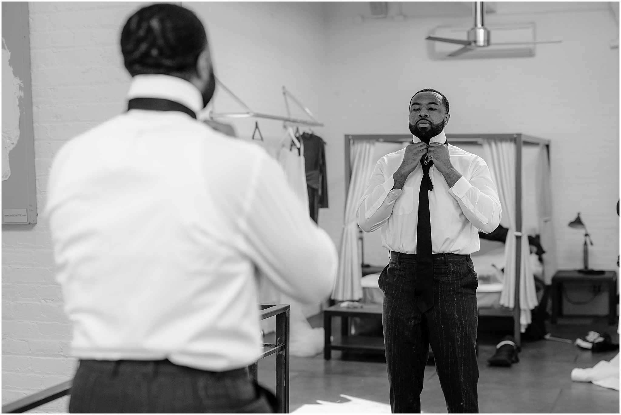 Groom fixing his collar and getting ready before their Intimate Fall Wedding at The Foundry LIC.
